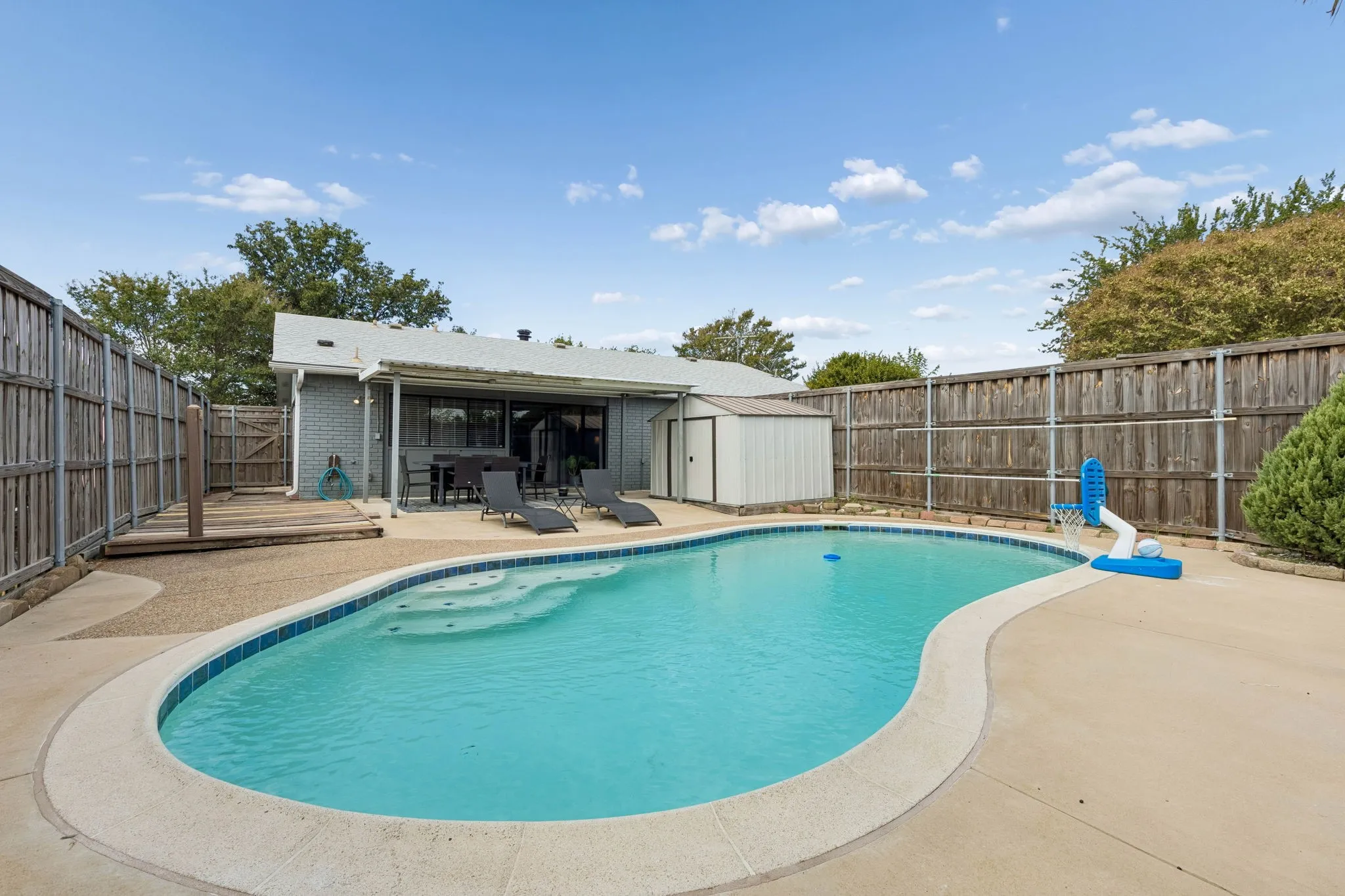 Freshly Resurfaced Pool - The backyard centers around a newly resurfaced pool with new water-level tile, creating a refreshed outdoor retreat with plenty of surrounding space to relax and recharge.