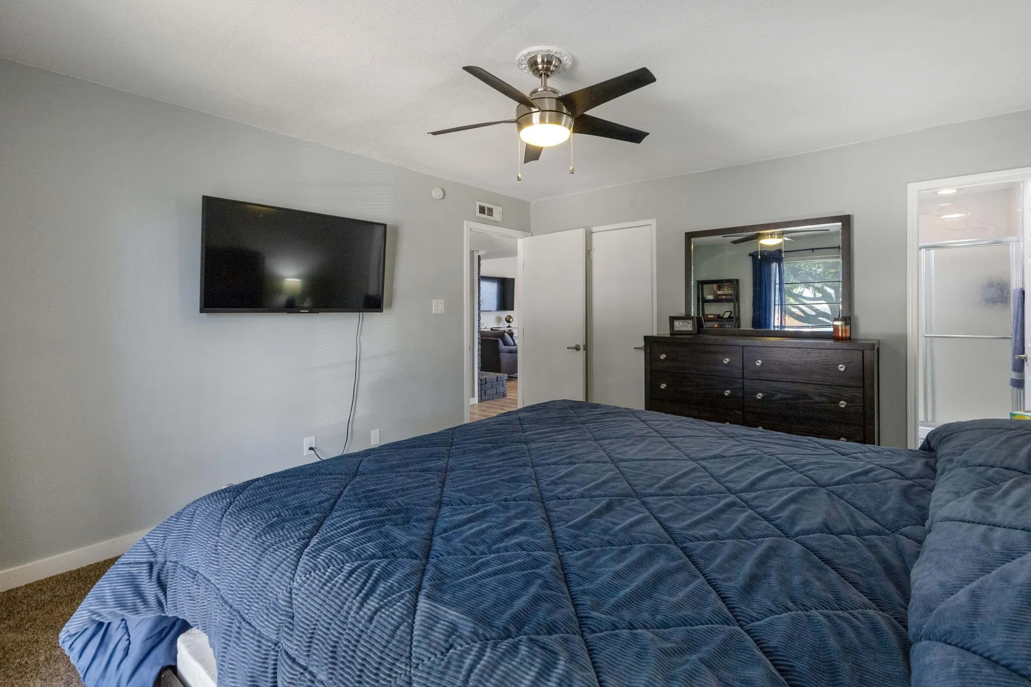 Private Bath Connection - Direct access to the updated primary bath adds everyday convenience, while the bedroom’s spacious proportions allow for flexible furniture placement and an uncluttered feel.