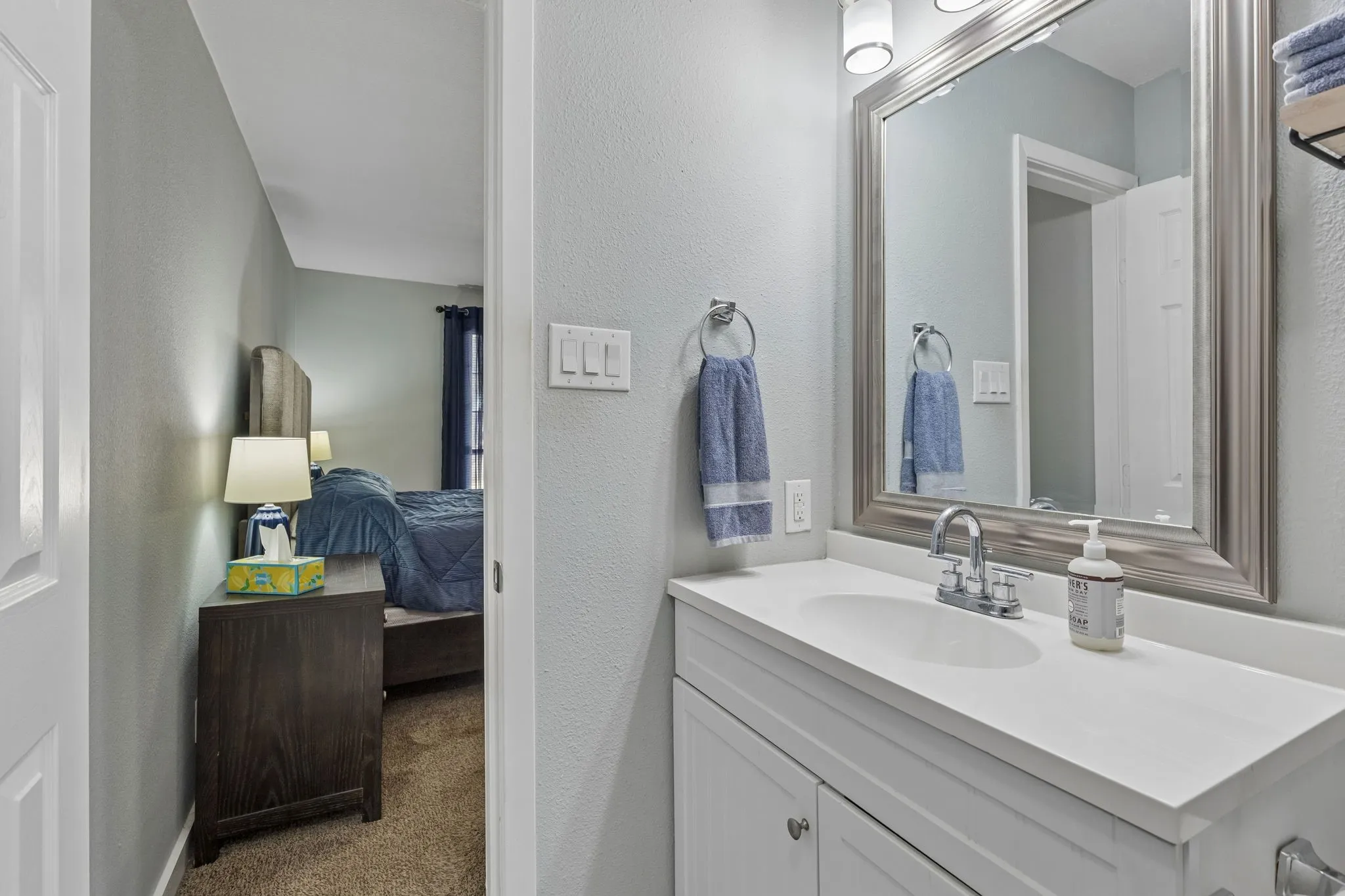 Thoughtful Ensuite Design - The updated vanity and streamlined finishes create a bright, functional getting-ready space with direct access from the primary bedroom.