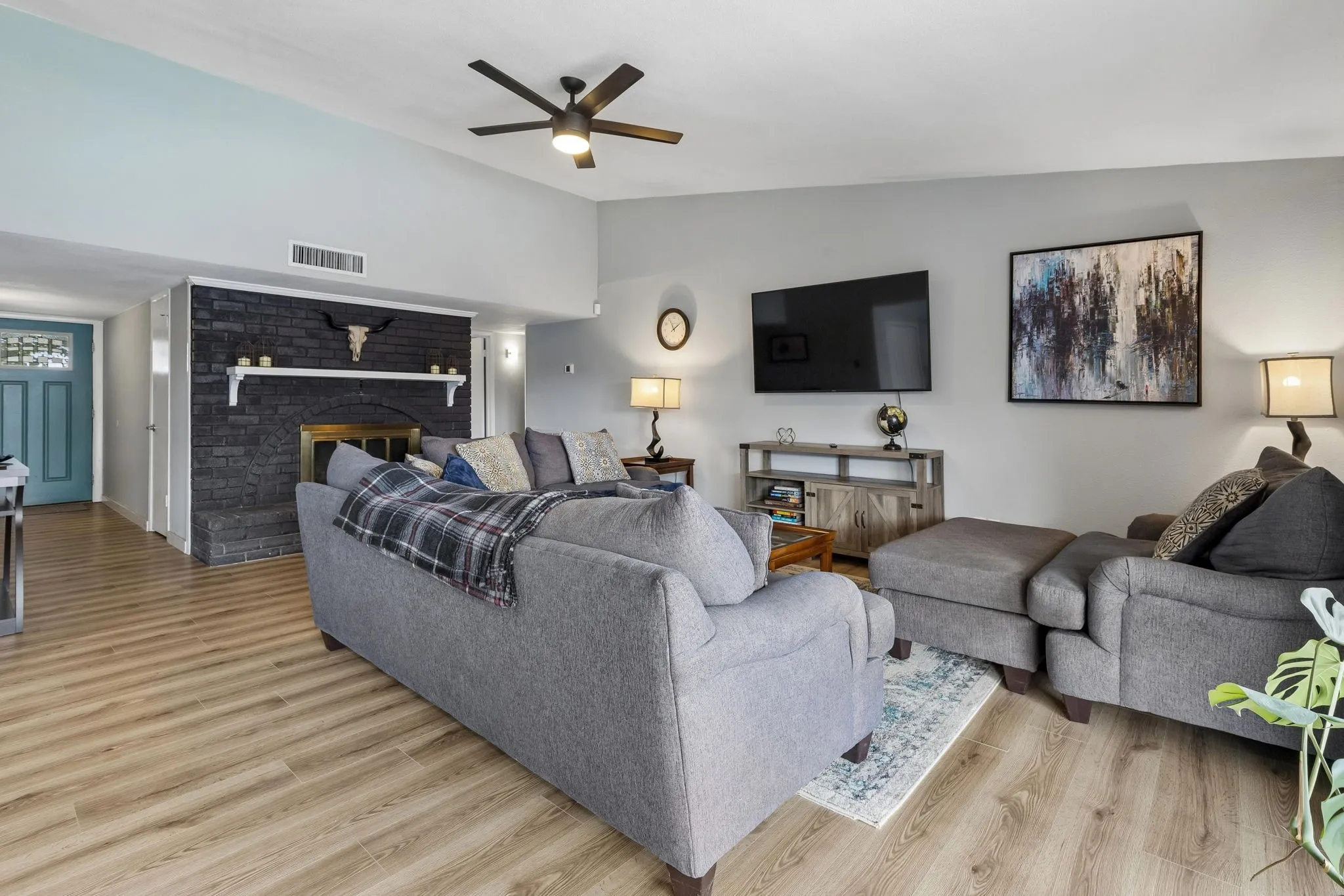 A Fireplace with Character - The brick-surround wood-burning fireplace provides an architectural focal point while the vaulted ceiling adds volume and dimension to the family room.