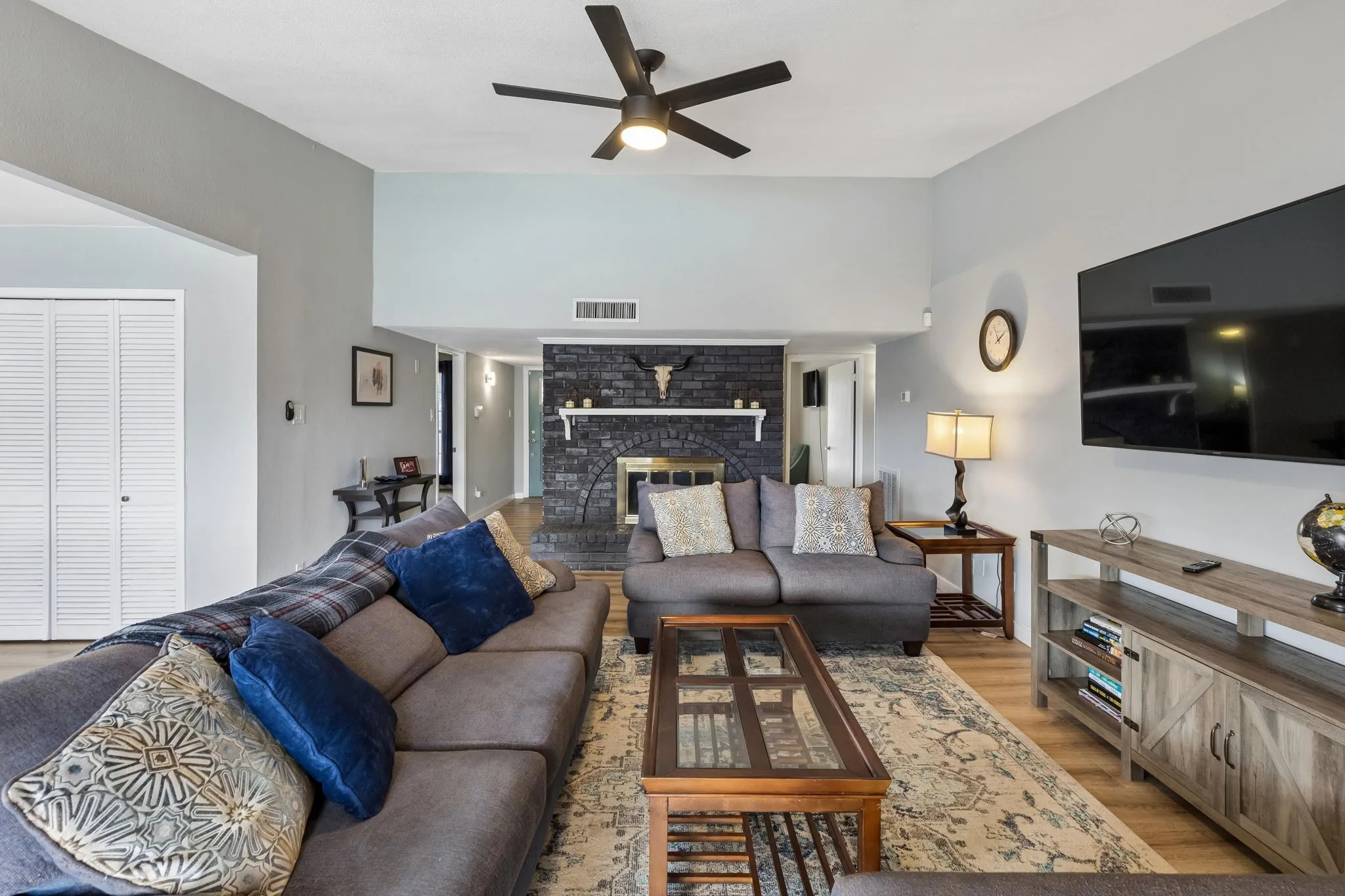 Warmth at the Heart of the Home - This angle showcases the fireplace as a defining feature of the living area while highlighting the room’s spacious proportions and easy circulation.