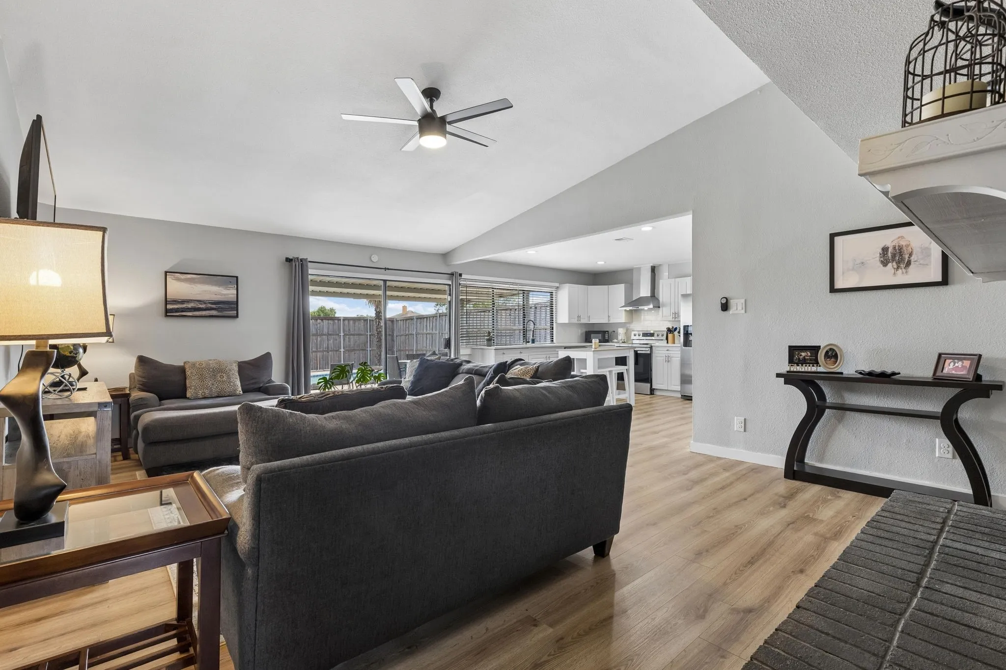 Open Living at Its Best - The family room flows naturally into the kitchen, creating an easy connection between cooking, gathering, and outdoor living beside the pool.