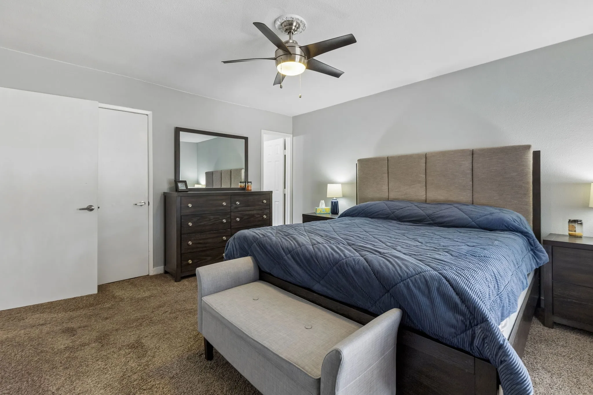 Room to Settle In - The primary bedroom offers generous wall space, a practical layout, and convenient access to both storage and the adjoining bath.