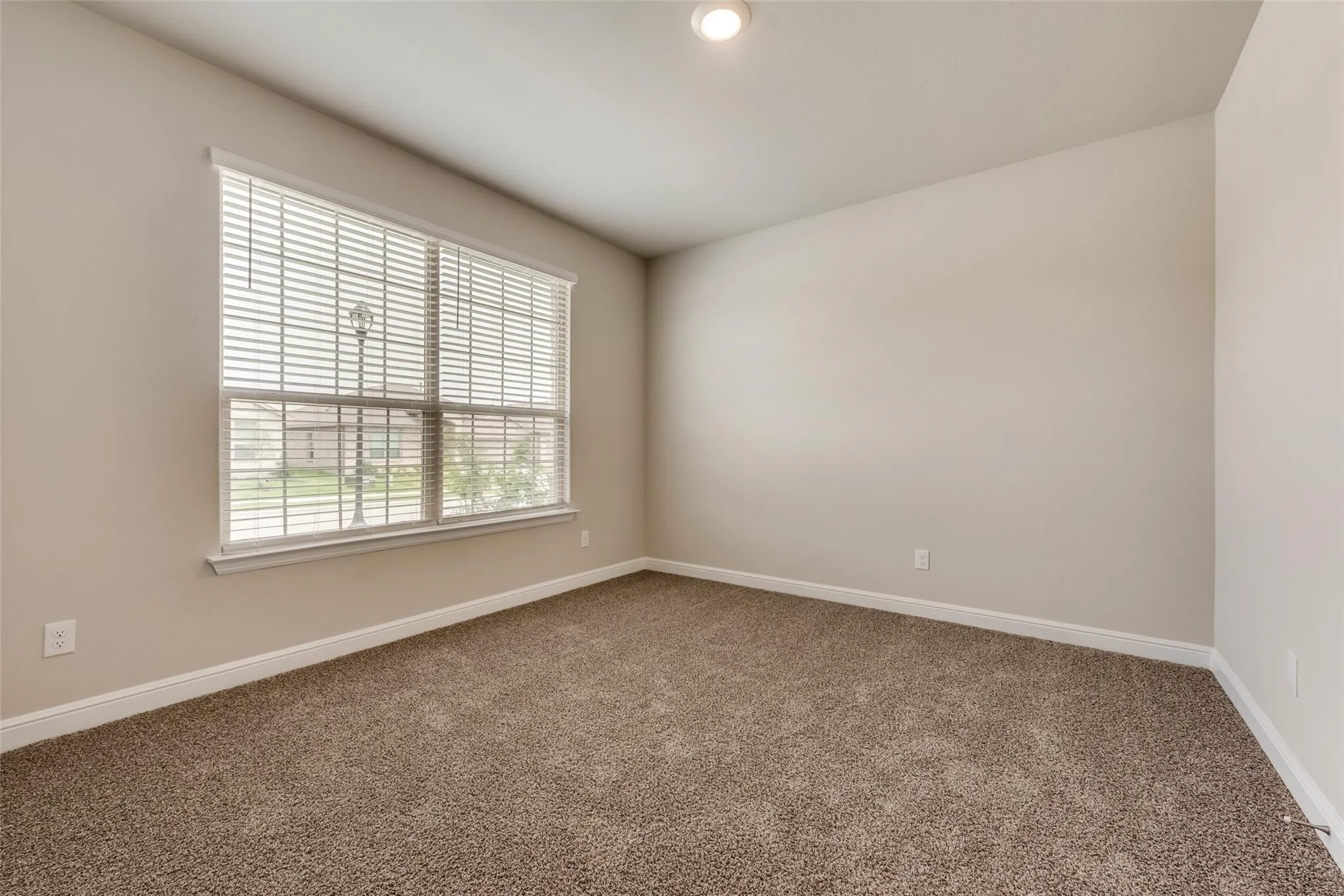 Carpeted empty room featuring plenty of natural light