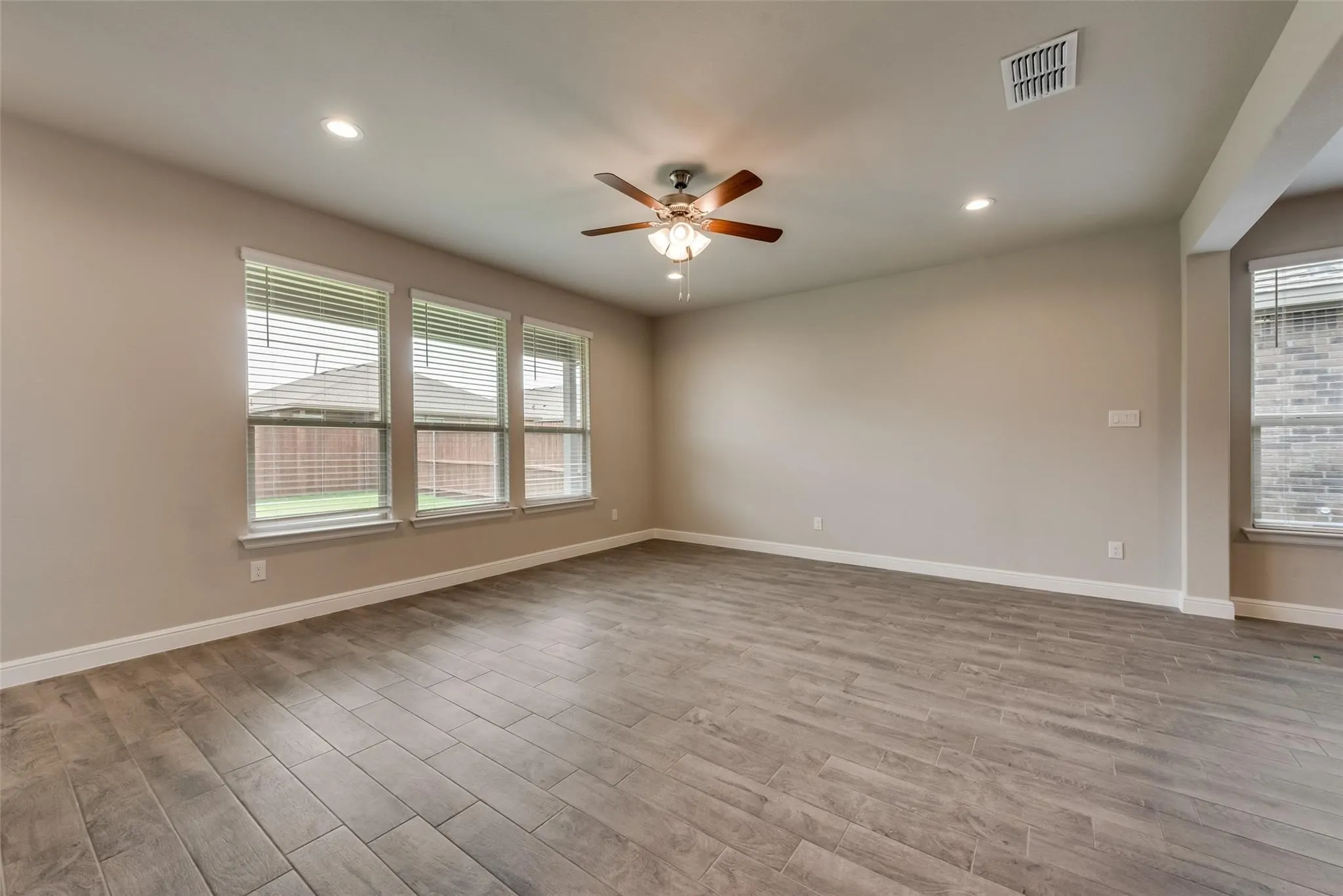 Empty room featuring ceiling fan and hardwood / wood-style floors