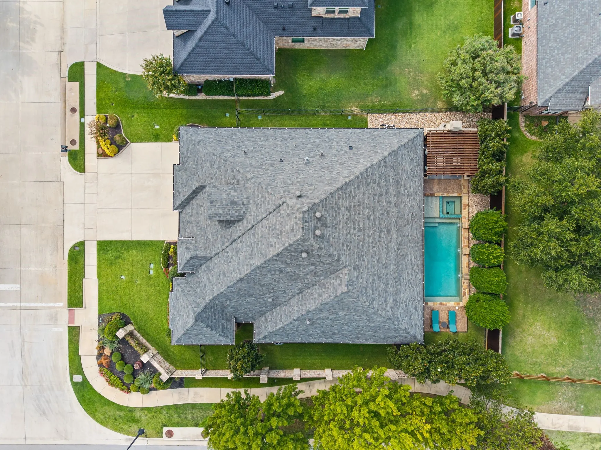 Spacious property featuring a swimming pool, adjacent spa, and a wooden deck