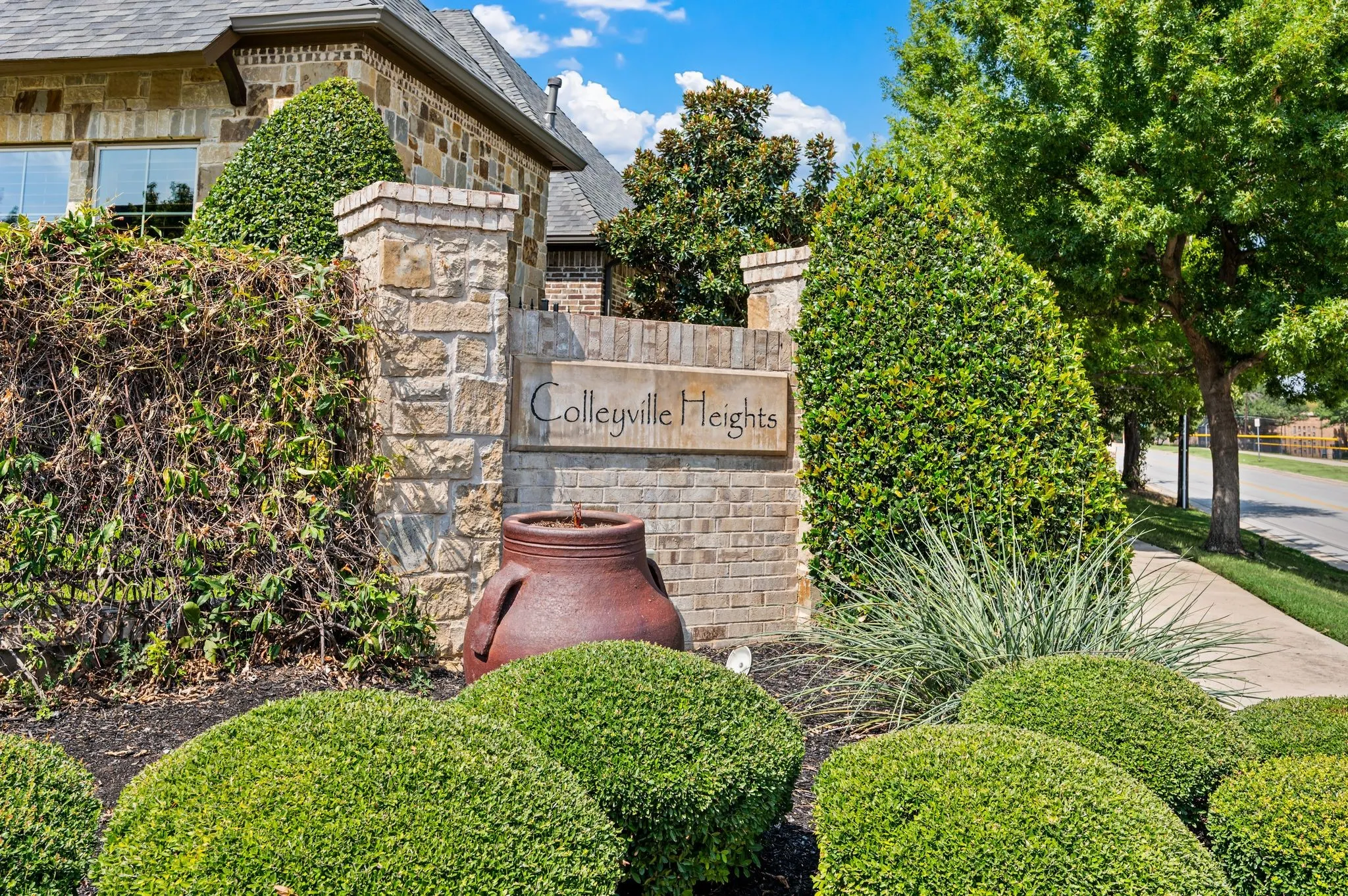 Stone entry monument featuring "Colleyville Heights" signage
