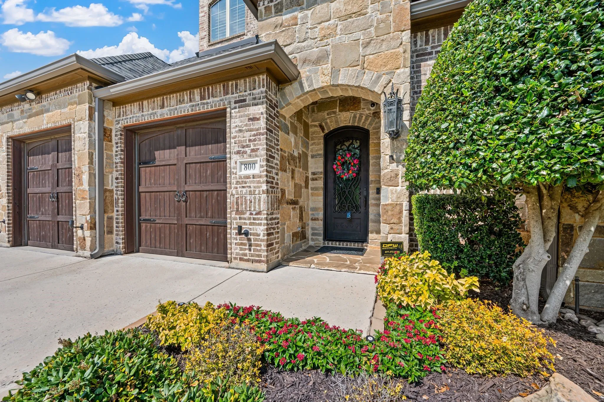 Brick and stone exterior with an arched entry