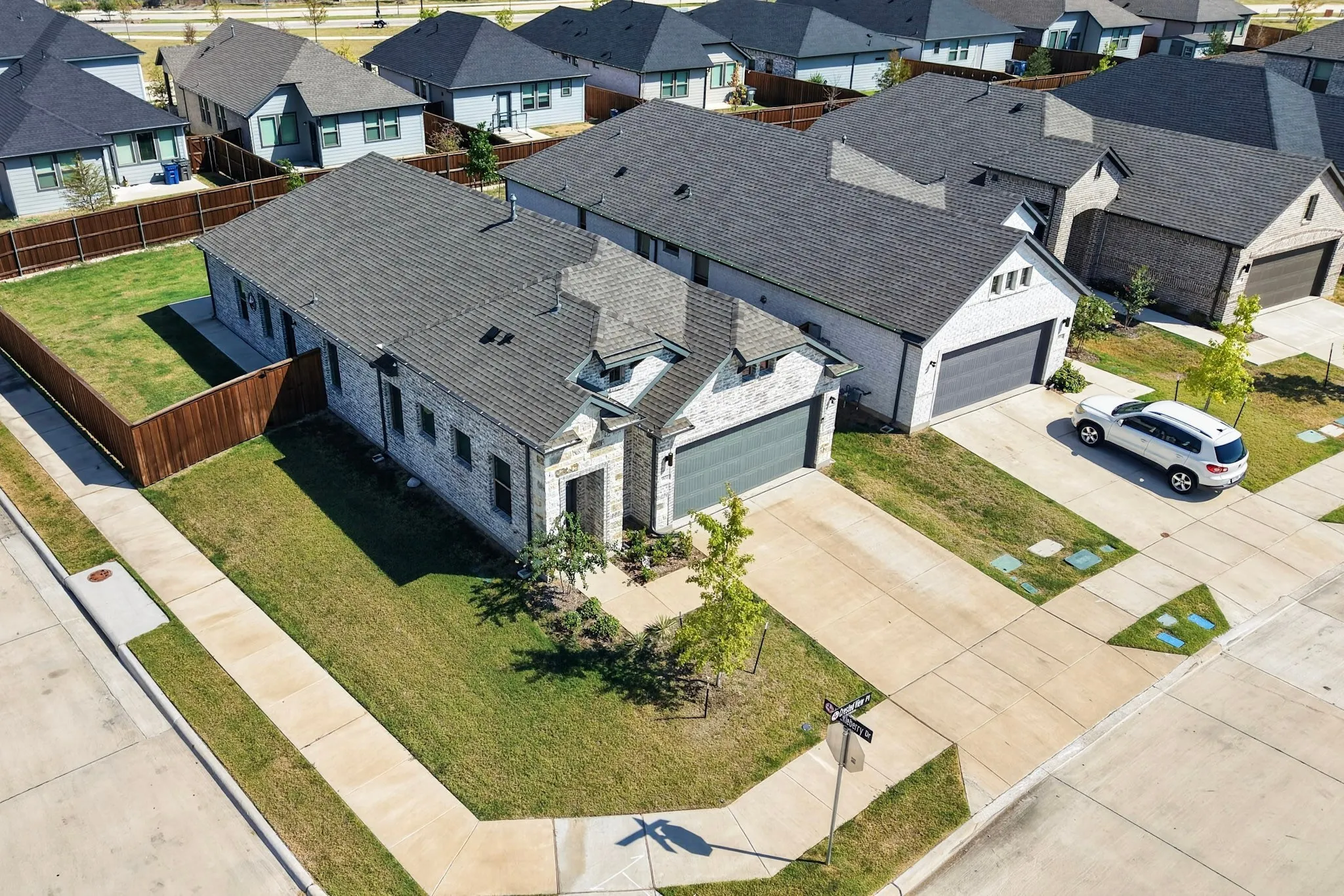 Stone and brick exterior with a dark grey shingled roof