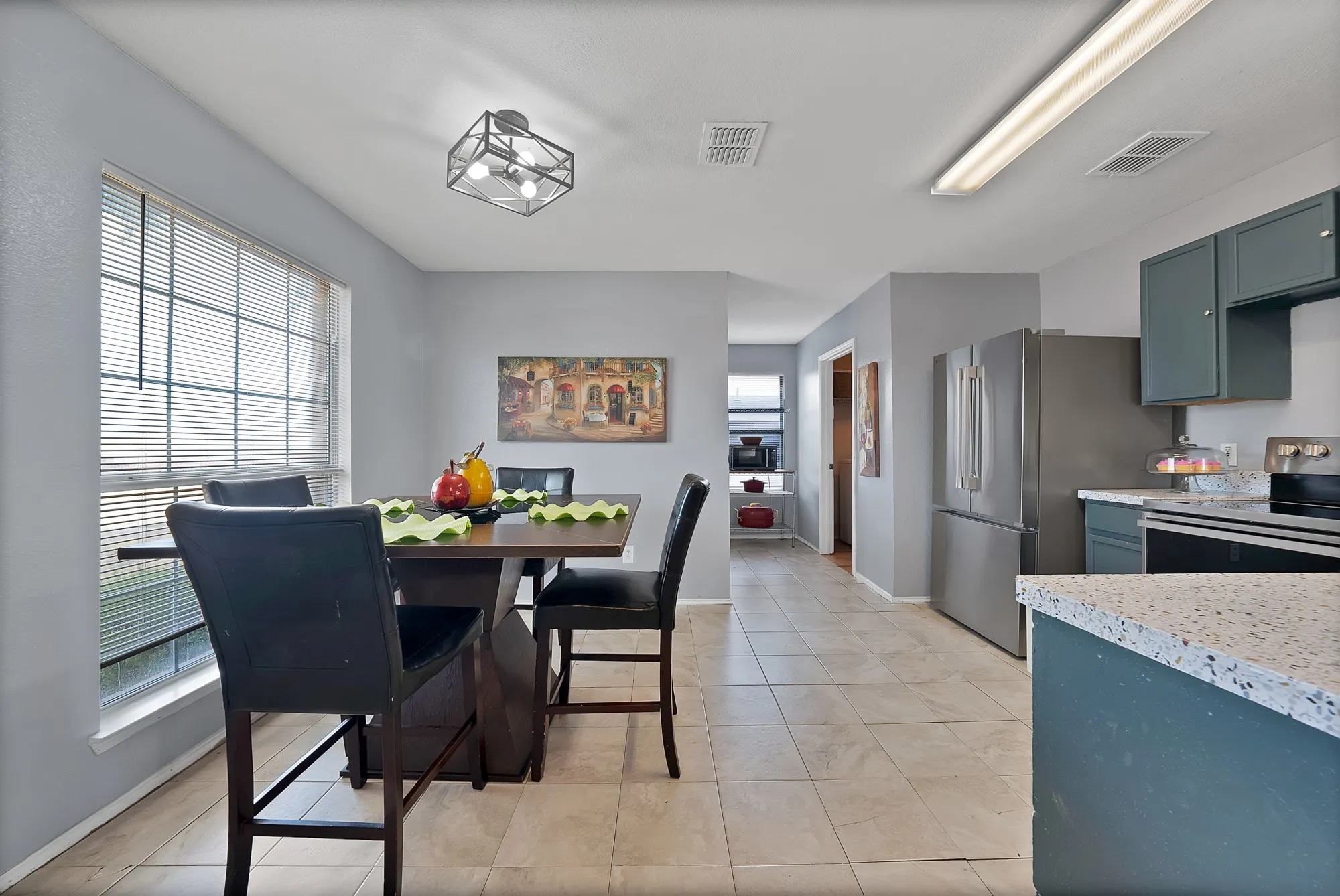 Expansive tiled flooring spans the open-concept space