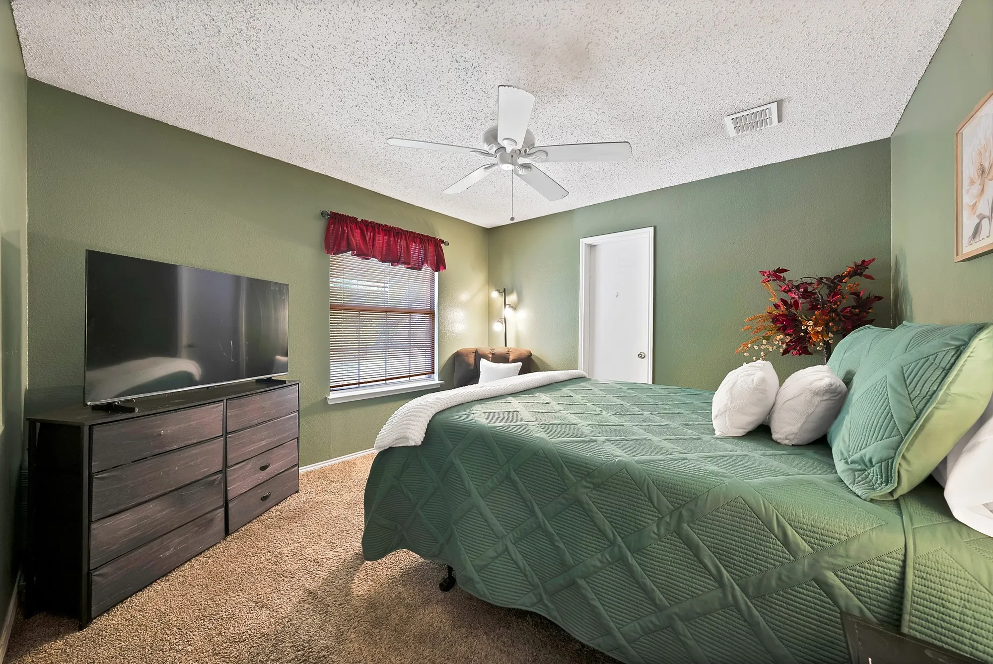 Carpeted room with a ceiling fan, window with blinds, and painted walls