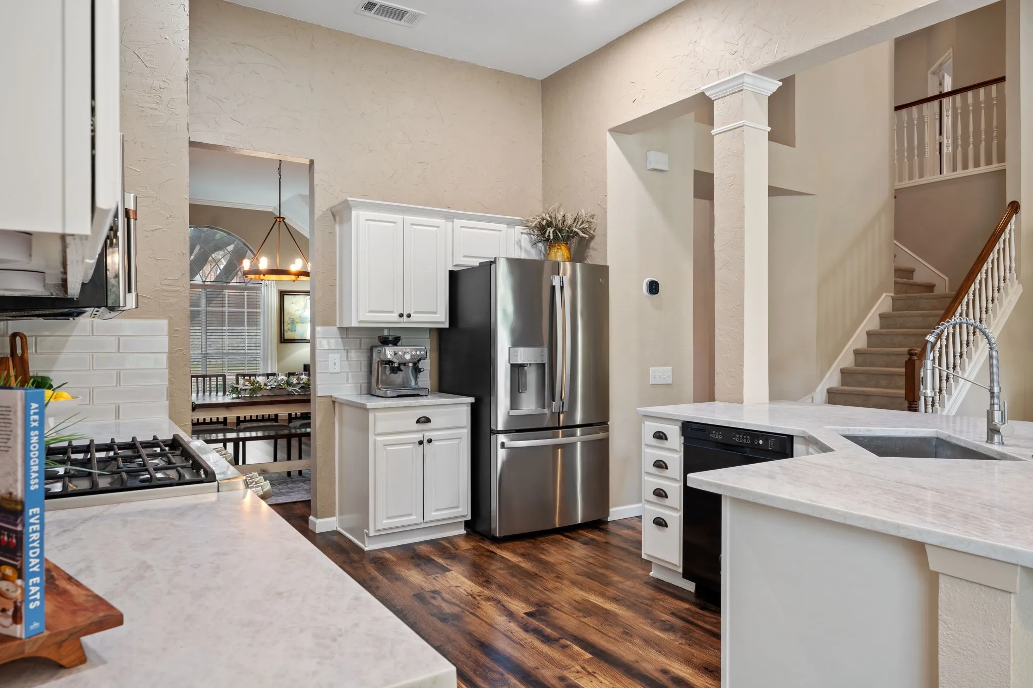 Kitchen with white cabinetry, quartz countertops, and gorgeous flooring