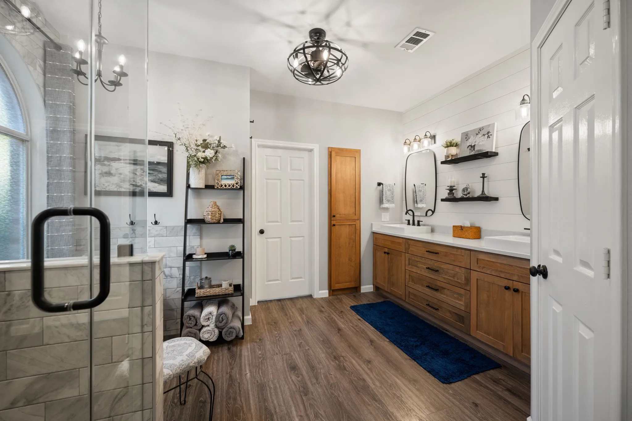Stunning primary bathroom remodeled in 2023 with freestanding tub, shower, wood vanity with double sinks