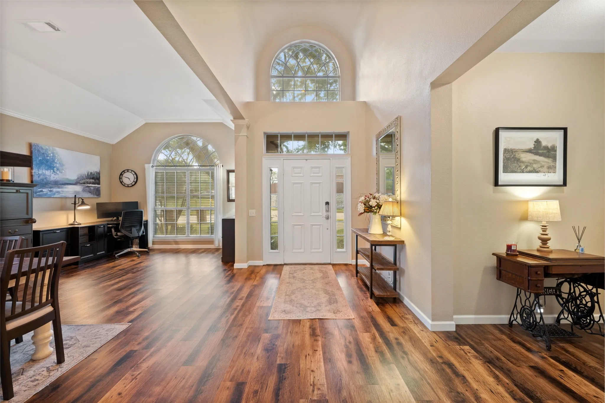 Grand entryway featuring gorgeous flooring, living flex space used as an office and large dining room