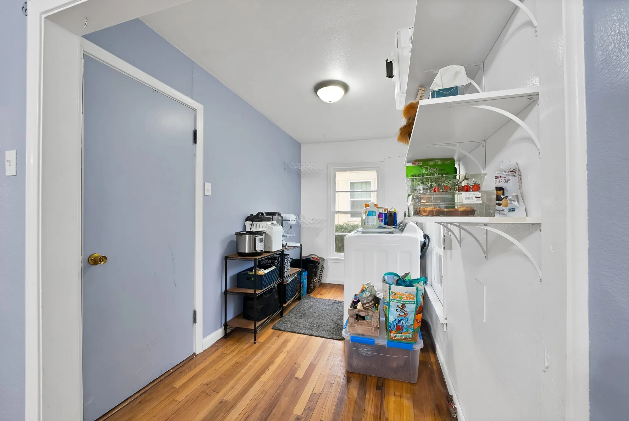 Wood-finish flooring with light blue and white painted walls
