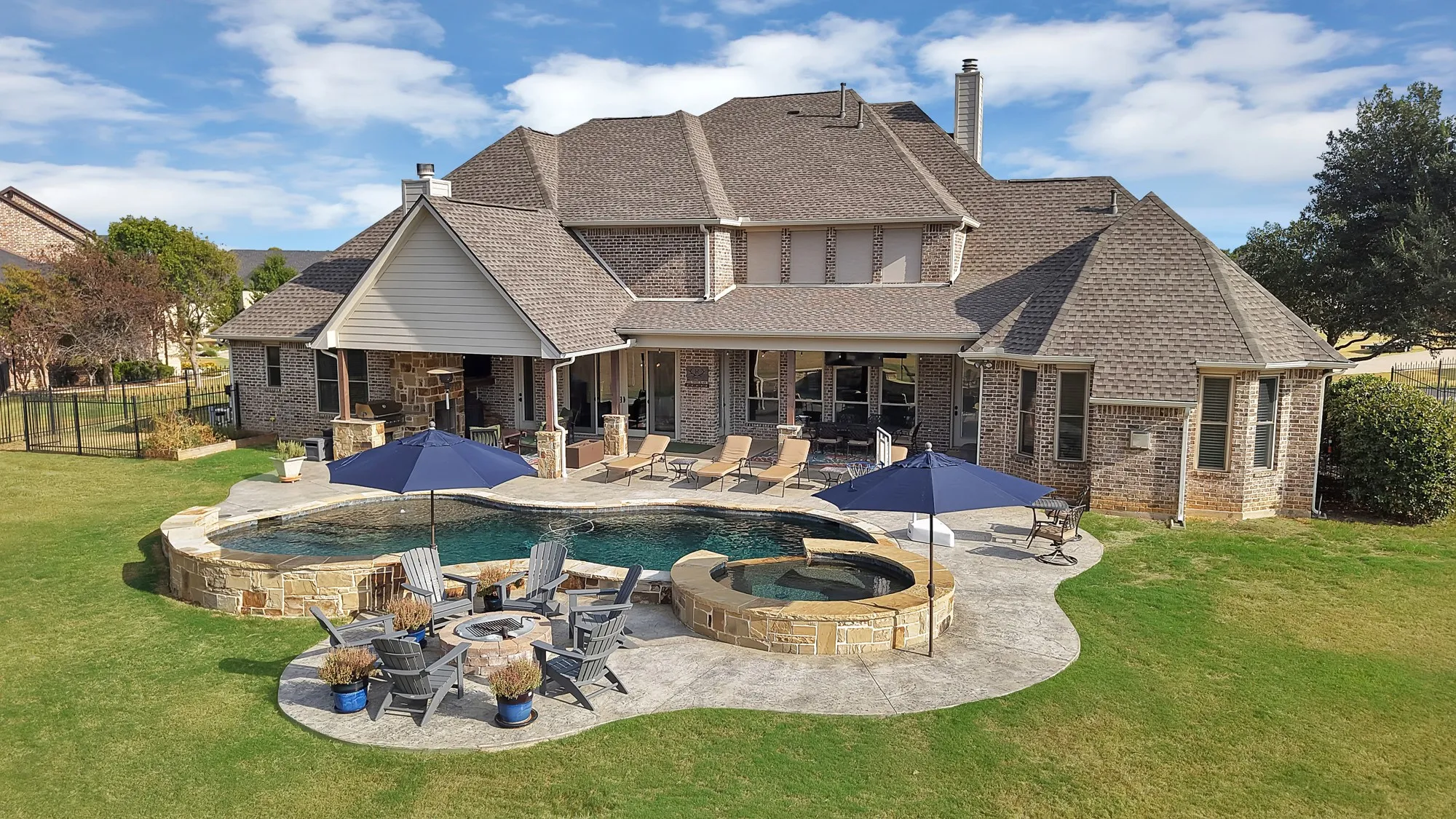 Brick exterior residence with a multi-level new composition shingle roof