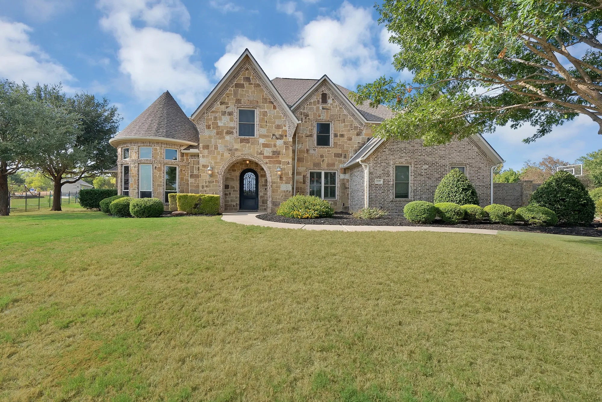 Stone and brick exterior with an arched entryway