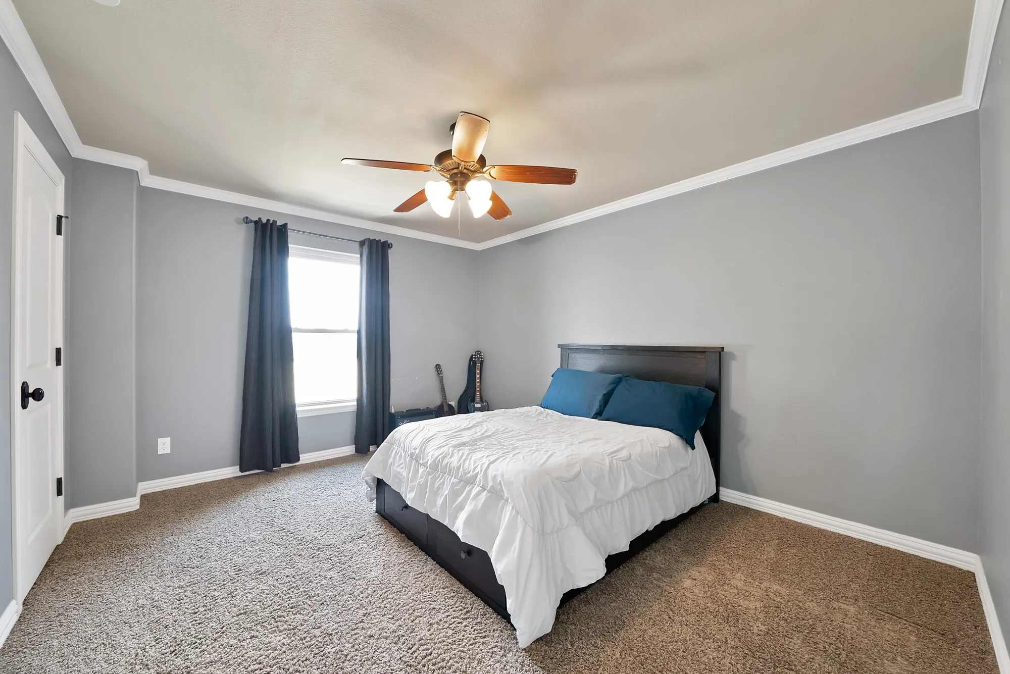 Recessed lighting, ceiling fan with light fixture, window with trim, crown molding, and carpeted flooring