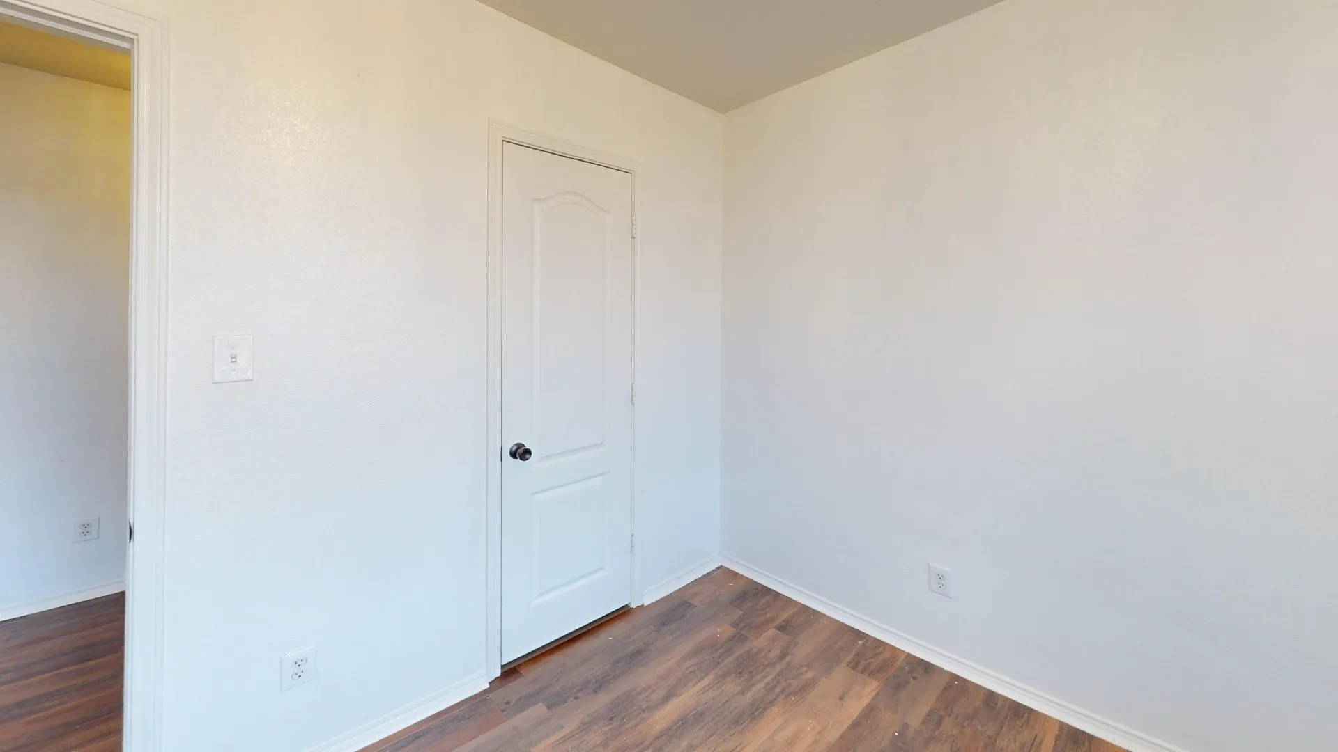White painted walls and wood-finish flooring