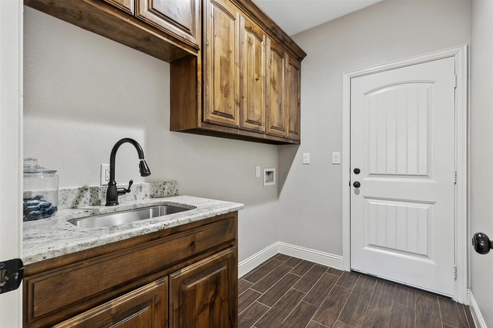 Granite-style countertop with an undermount sink and matte black faucet