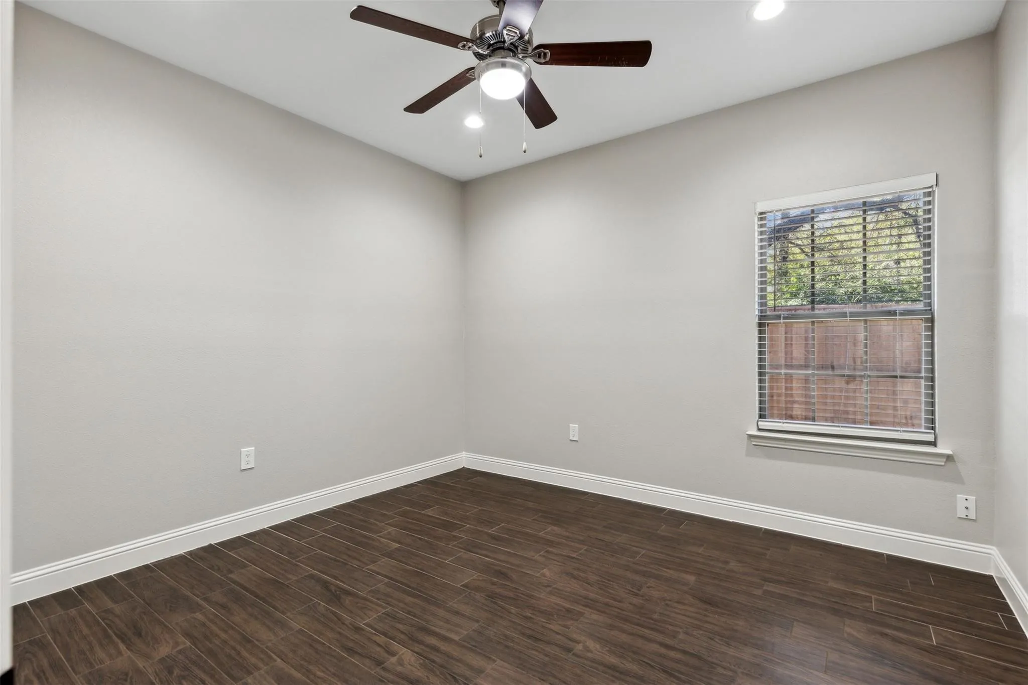 Wood-look tile flooring, ceiling fan with integrated lighting, recessed lighting, and a window with blinds