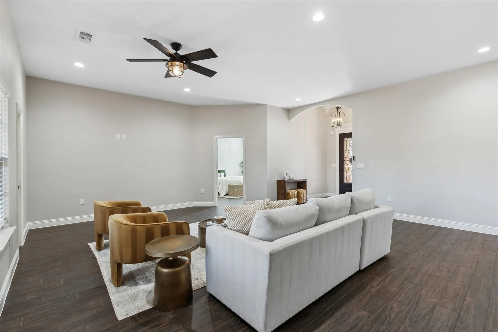 Spacious room with dark wood-finish flooring, recessed lighting, and a ceiling fan