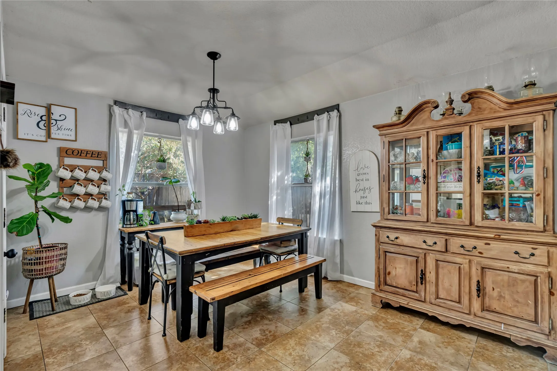 Recessed windows with natural light, tile flooring, and a multi-light ceiling fixture