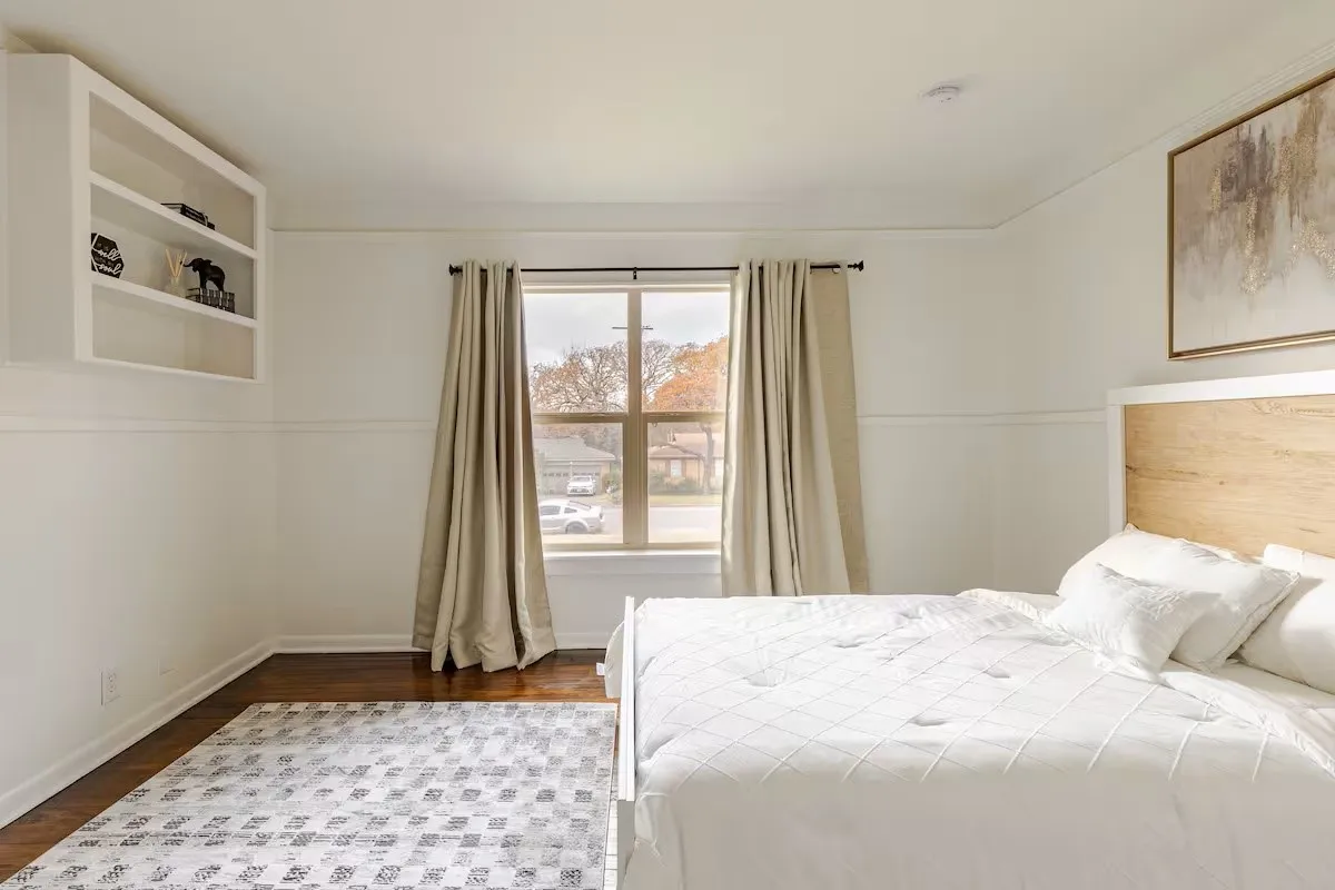Hardwood-finish flooring, built-in shelving, crown molding, double-pane window, and decorative wall paneling