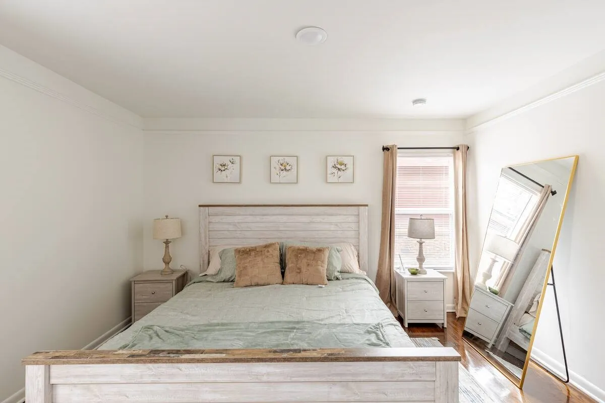 White walls with crown molding and polished wood flooring
