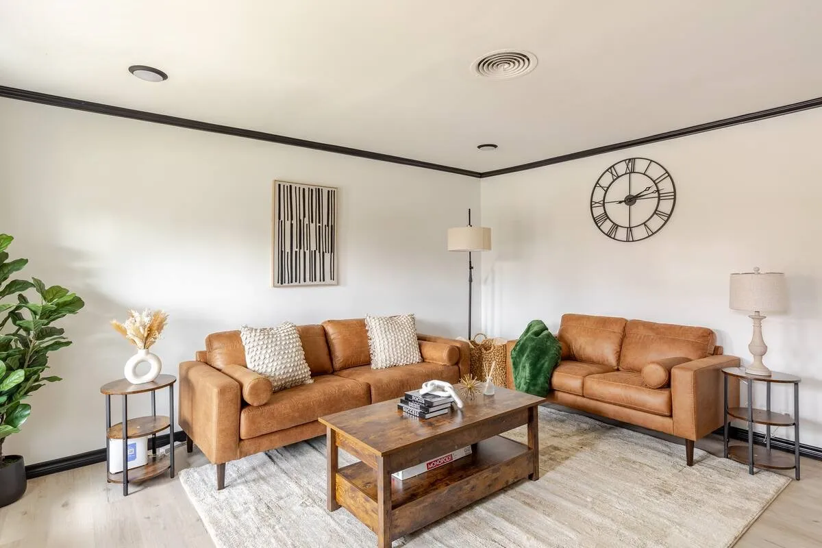 Recessed ceiling lighting, dark crown molding, light-toned flooring, and a ceiling vent