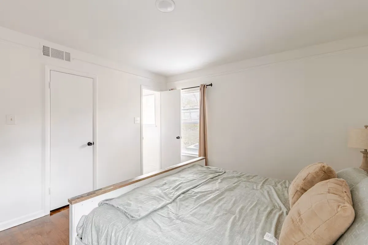Recessed ceiling lighting, wood-finish flooring, and white walls throughout