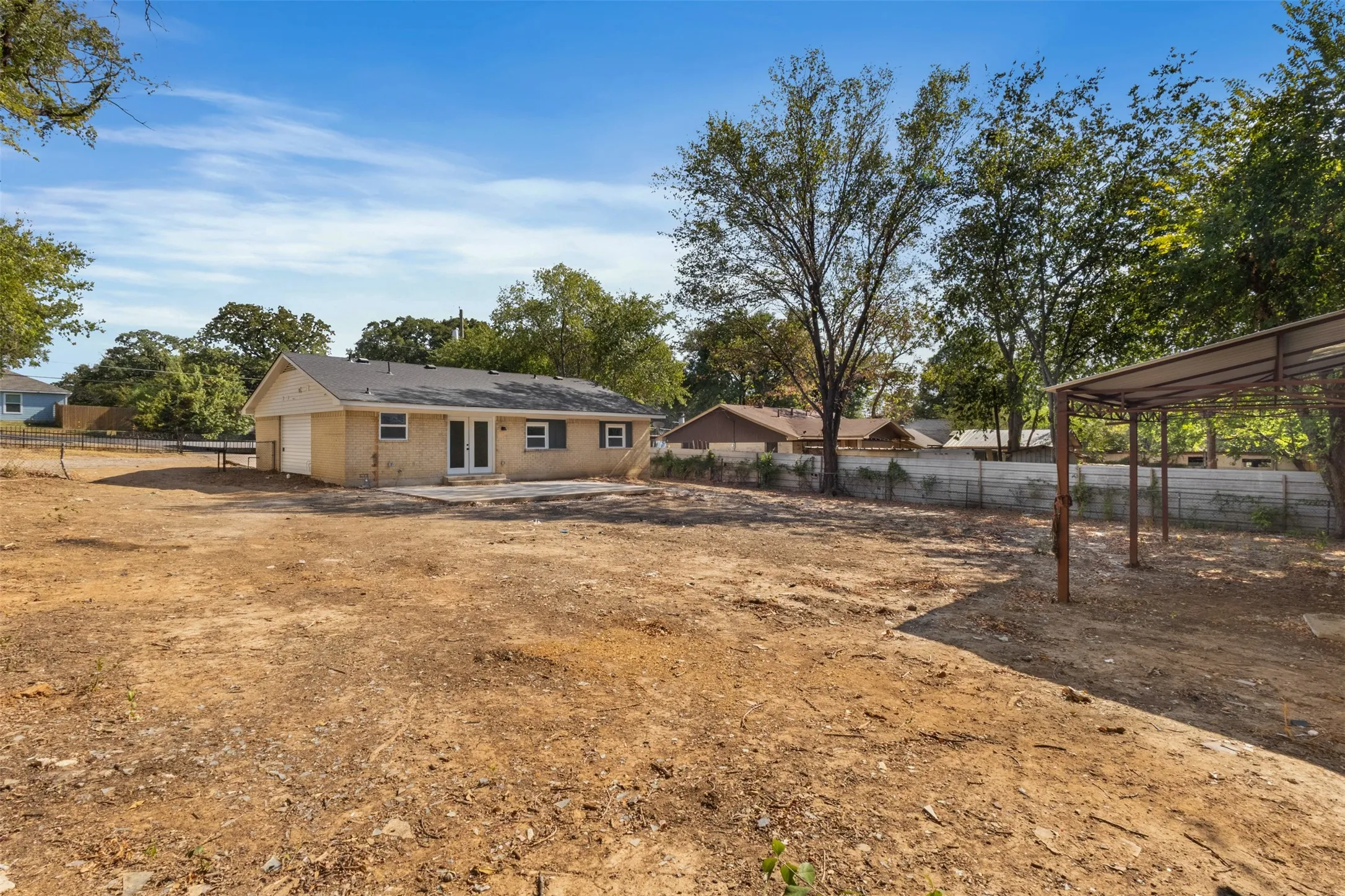 Expansive property with a brick exterior, attached garage, and a covered outdoor structure
