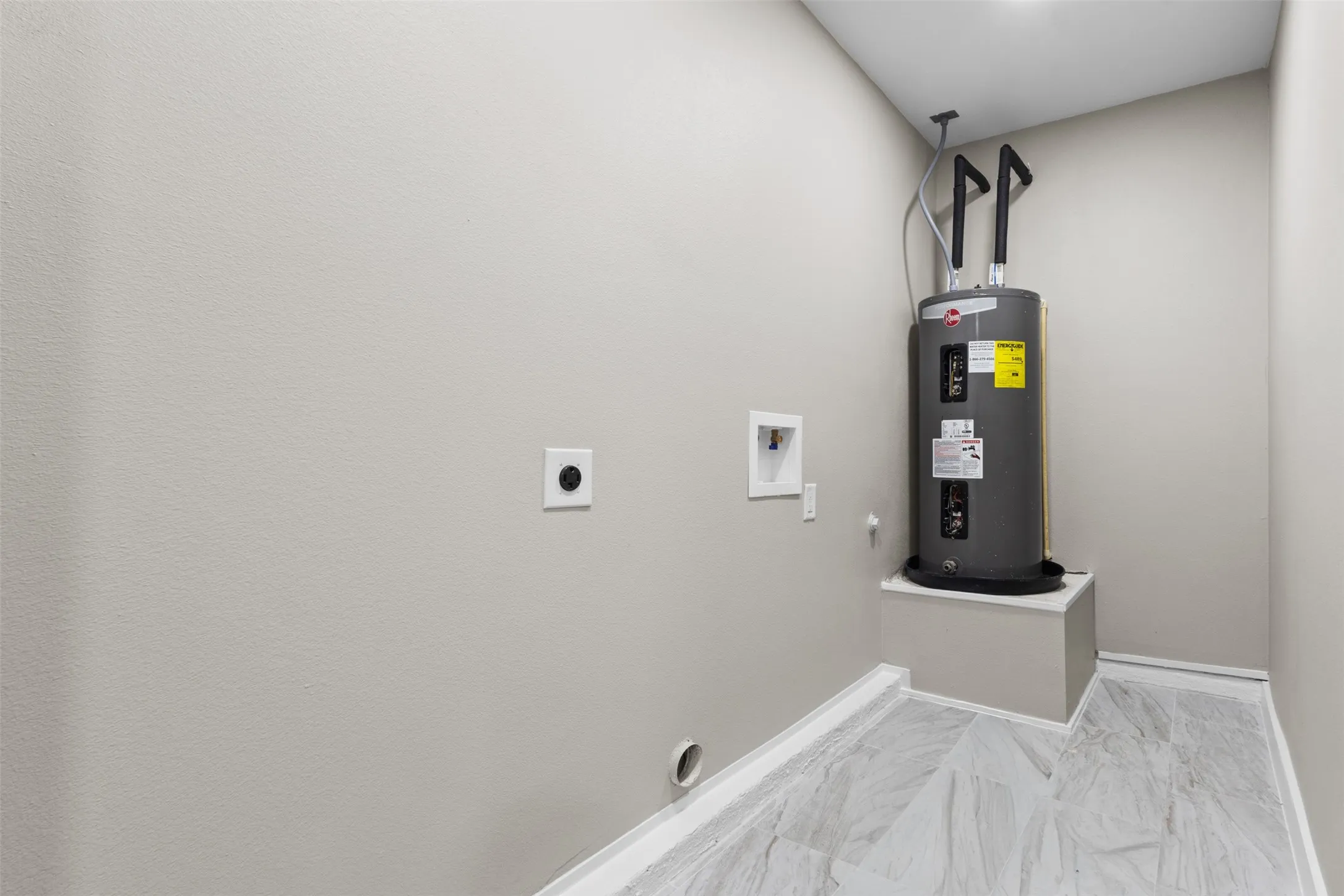 Water heater with a raised platform, light-toned wall paint, and wood-finish flooring