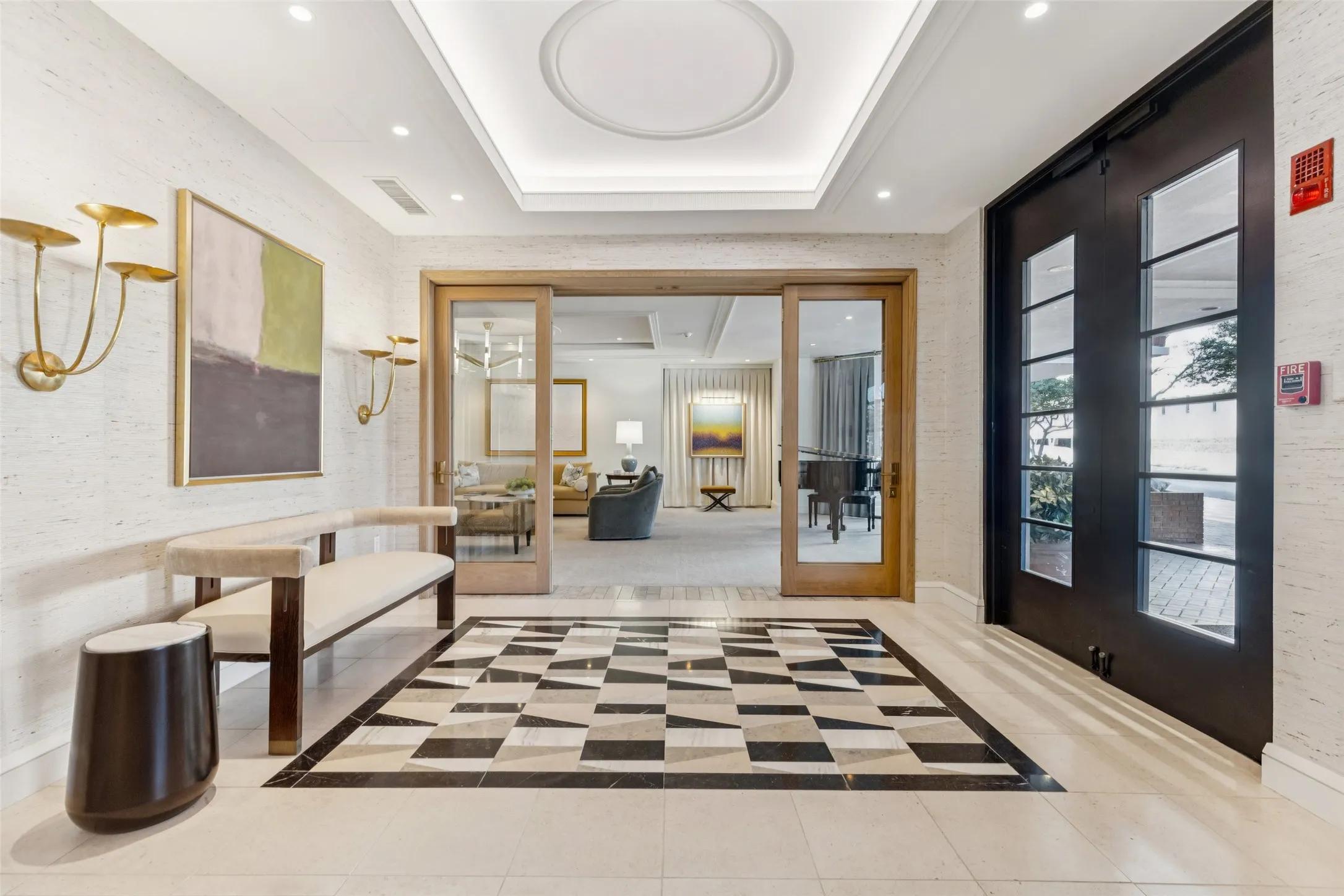 Recessed lighting, unique Recently remodeled building foyer flooring, double glass panel entry doors, tray ceiling, and sliding glass panel doors