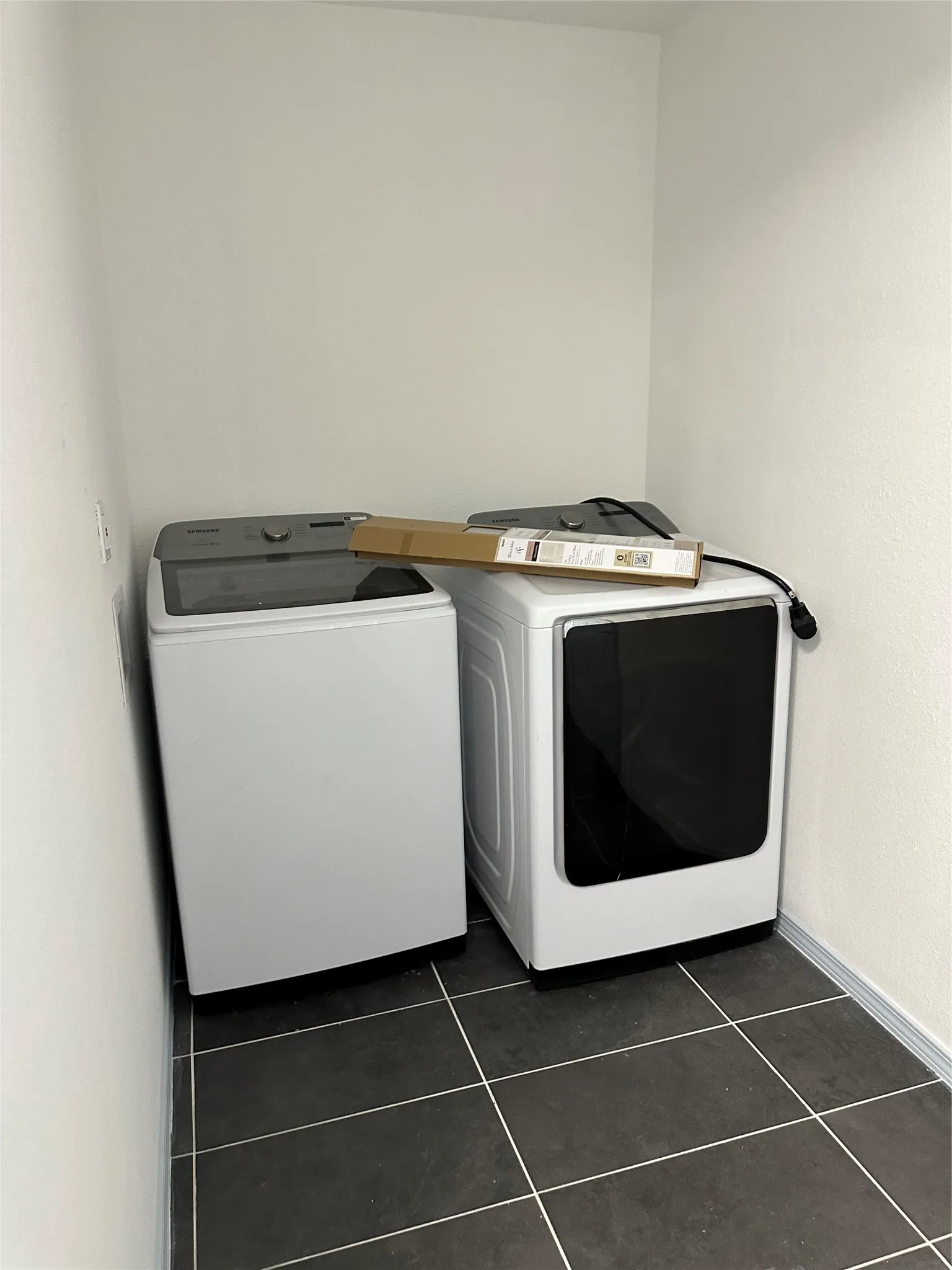 Laundry area featuring tiled flooring