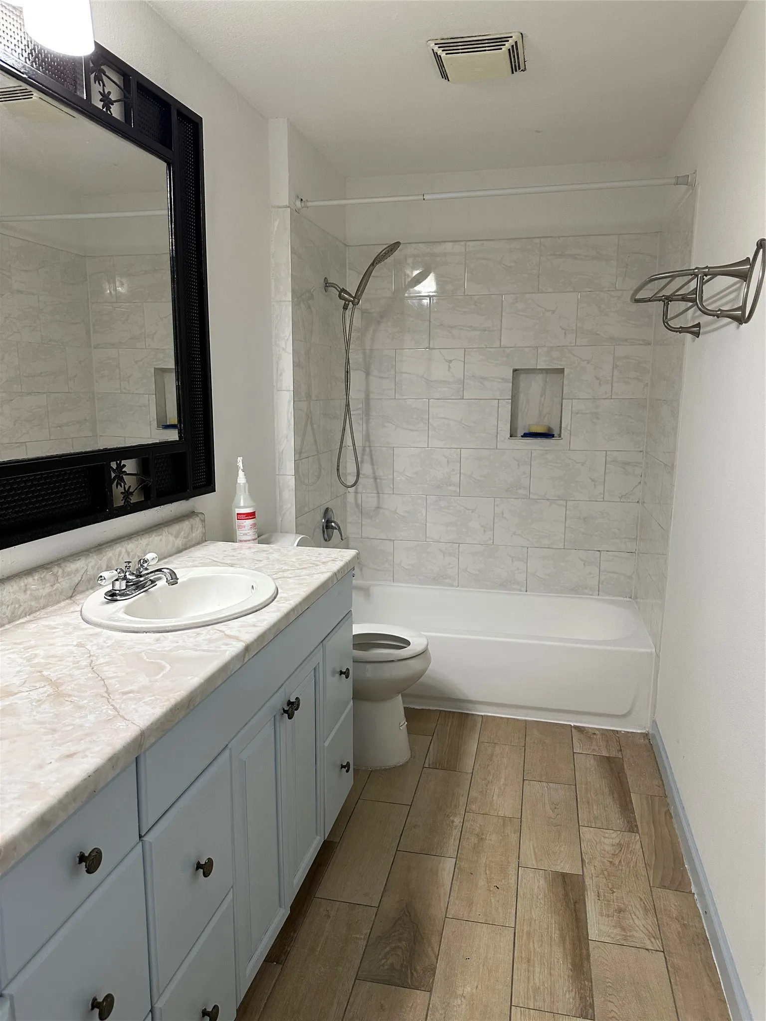Single vanity with an integrated sink, light-toned countertop, and light blue cabinetry