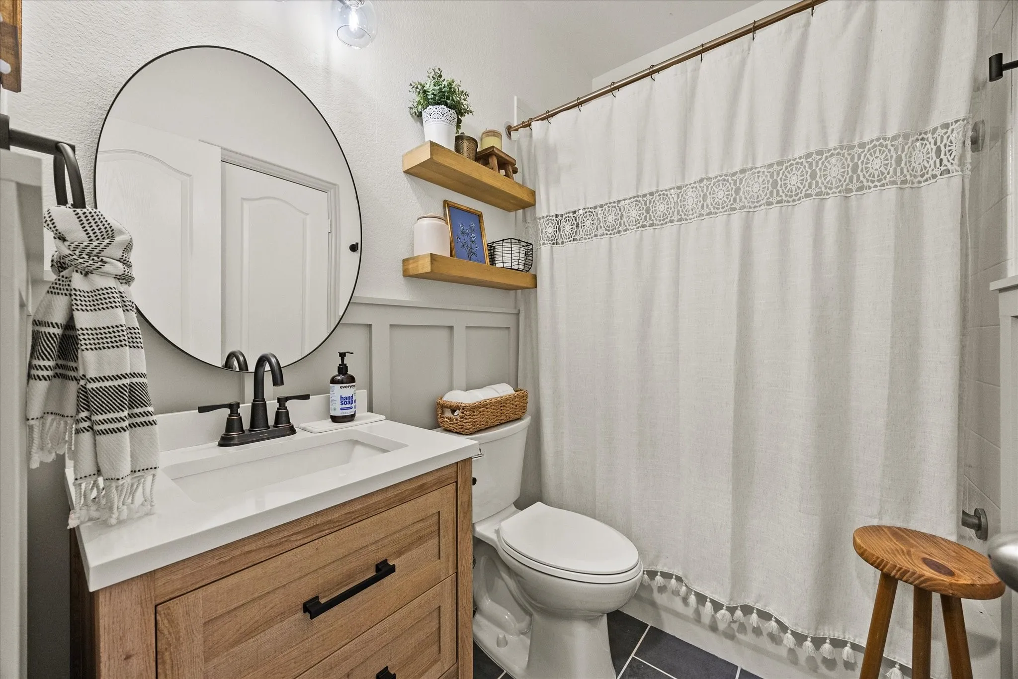 1602 Mapleleaf Drive Wylie, TX 75098 Vanity with integrated sink, matte black faucet, and round mirror