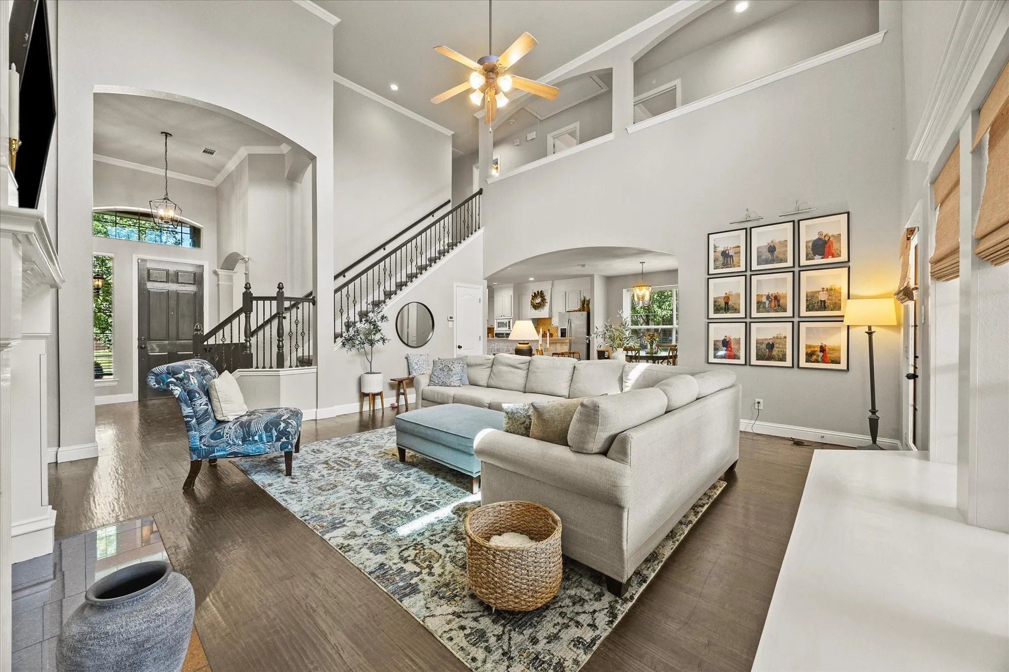 1602 Mapleleaf Drive Wylie, TX 75098 Two-story living area with high ceilings, wood-finish flooring, and a fireplace
