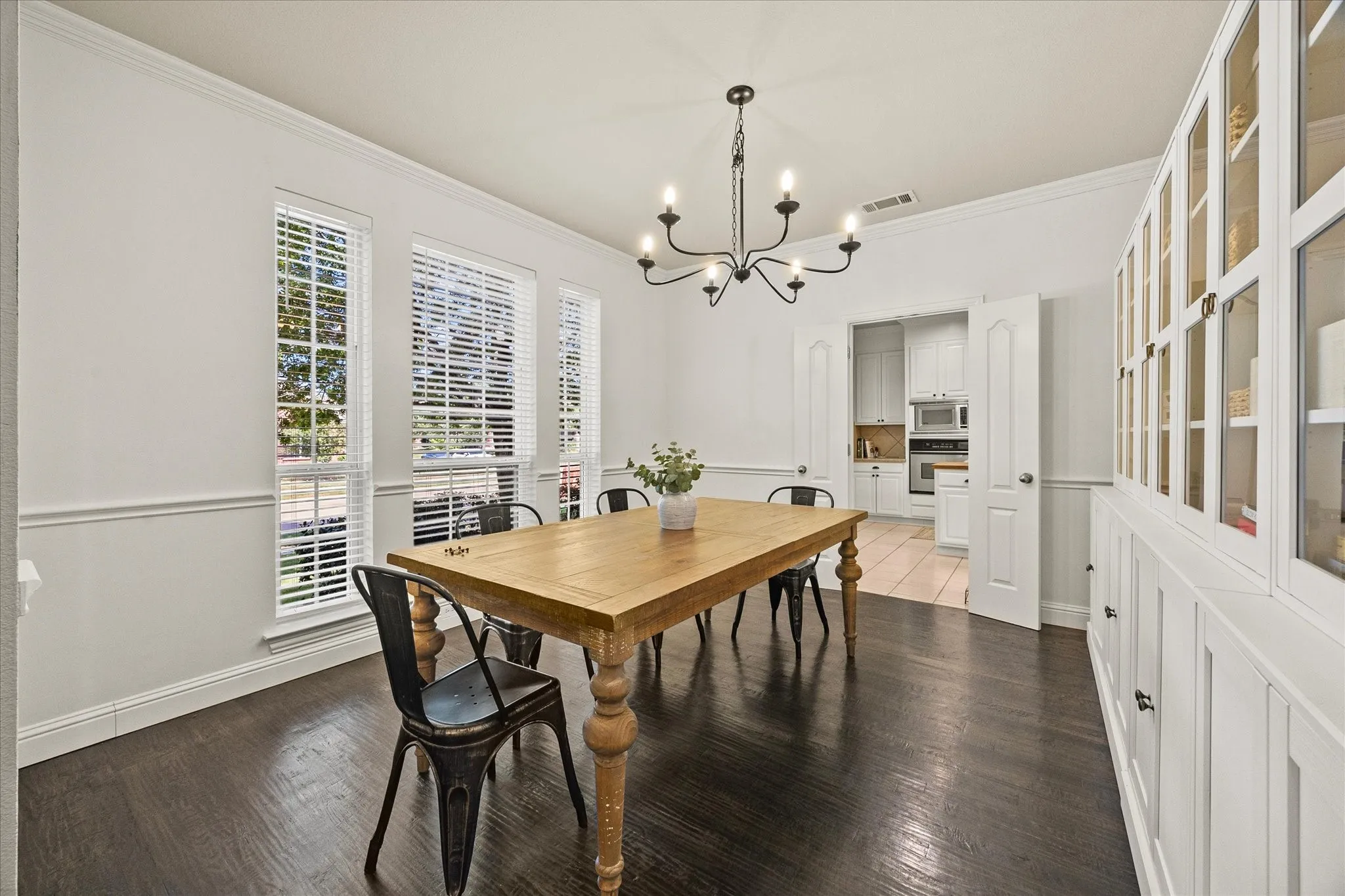 1602 Mapleleaf Drive Wylie, TX 75098 Dark wood-finish flooring with white wainscoting and crown molding