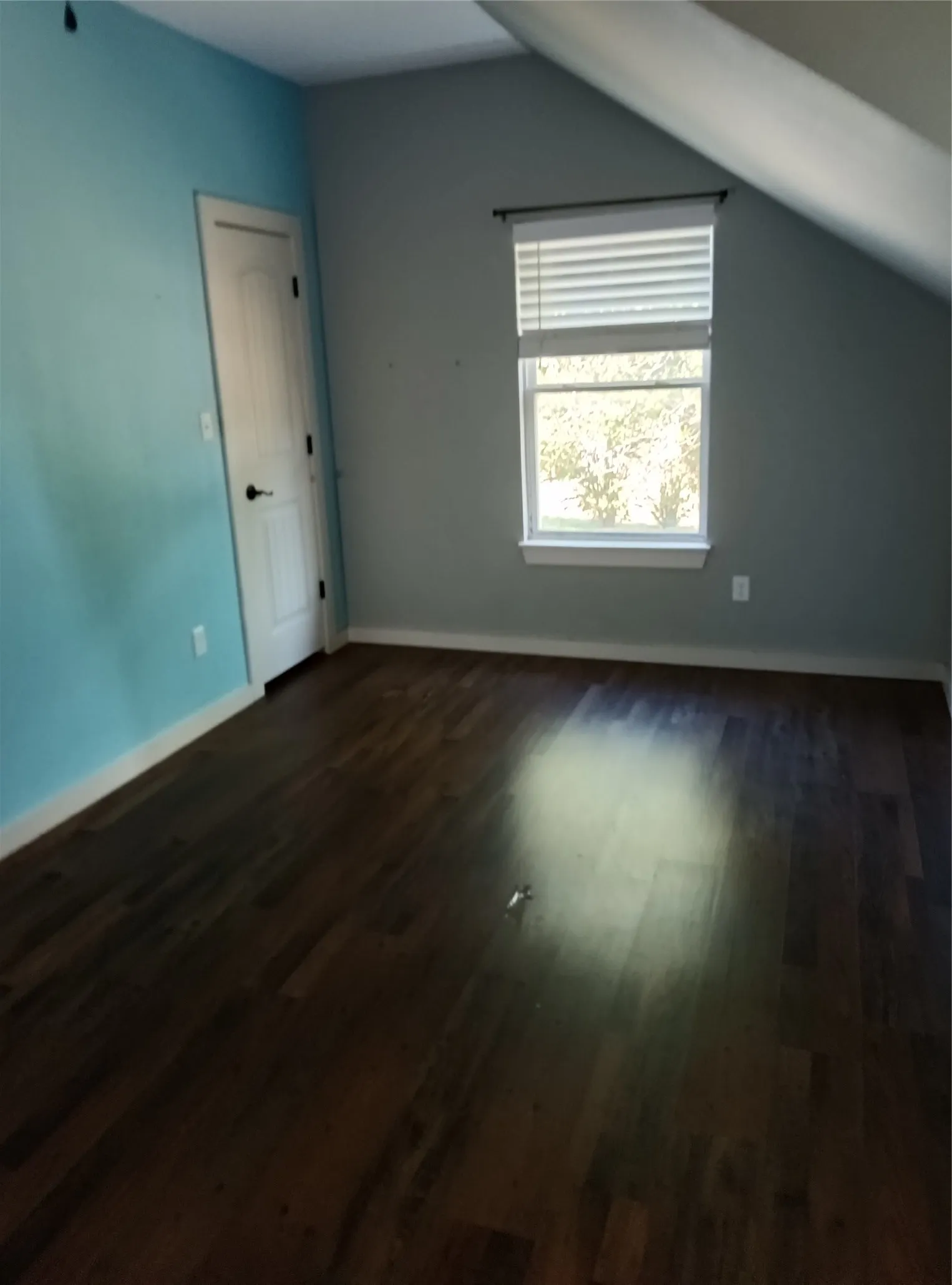 Wood-finish flooring with a window offering natural illumination