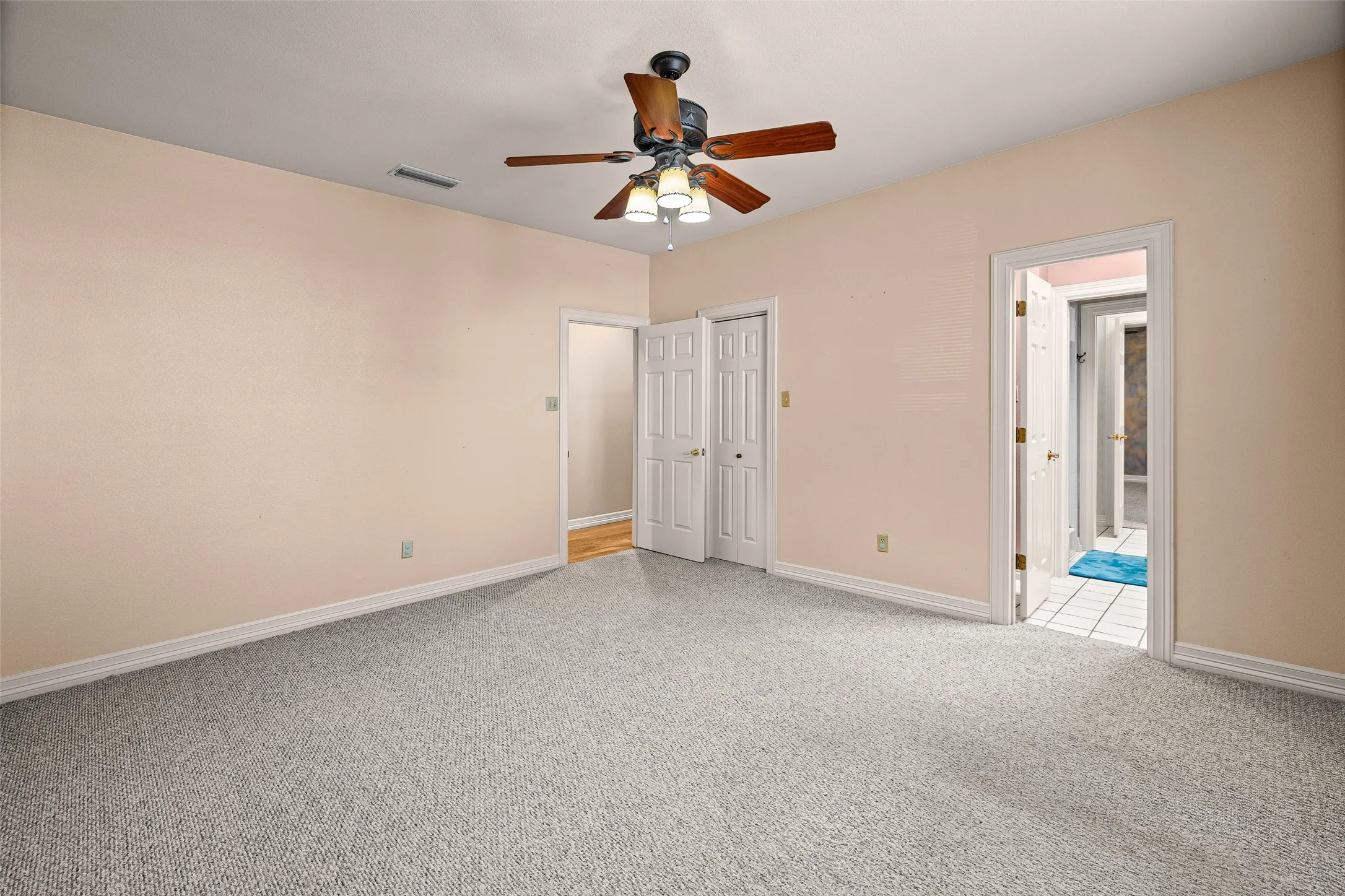 Neutral-toned walls complement plush carpeting