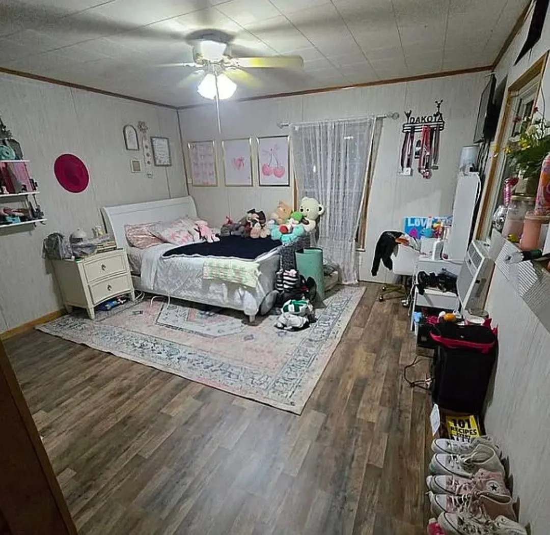 Wood-finish flooring with a ceiling fan light fixture