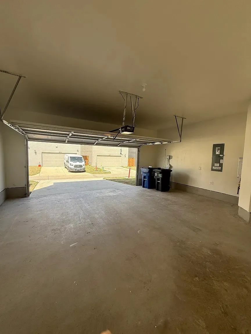 Attached garage with concrete flooring and an automatic garage door opener