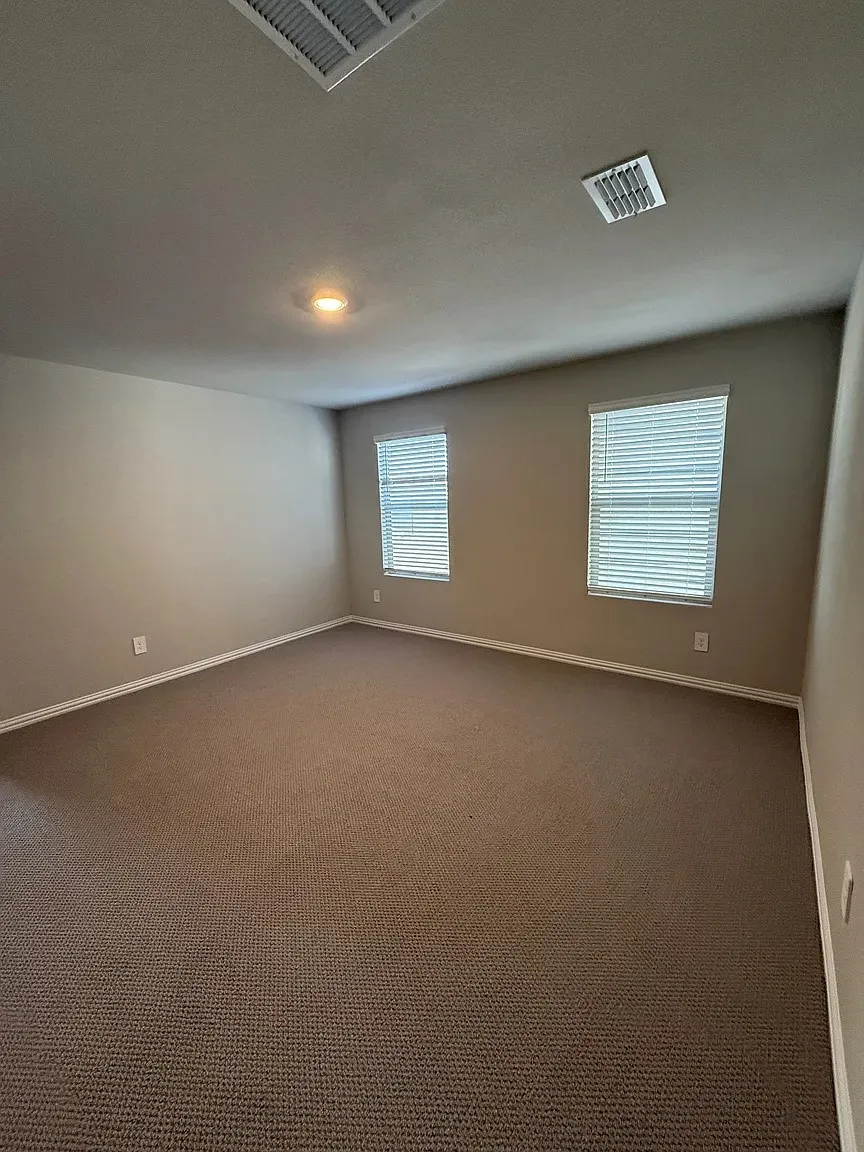 Carpeted flooring, recessed lighting, and dual windows with blinds