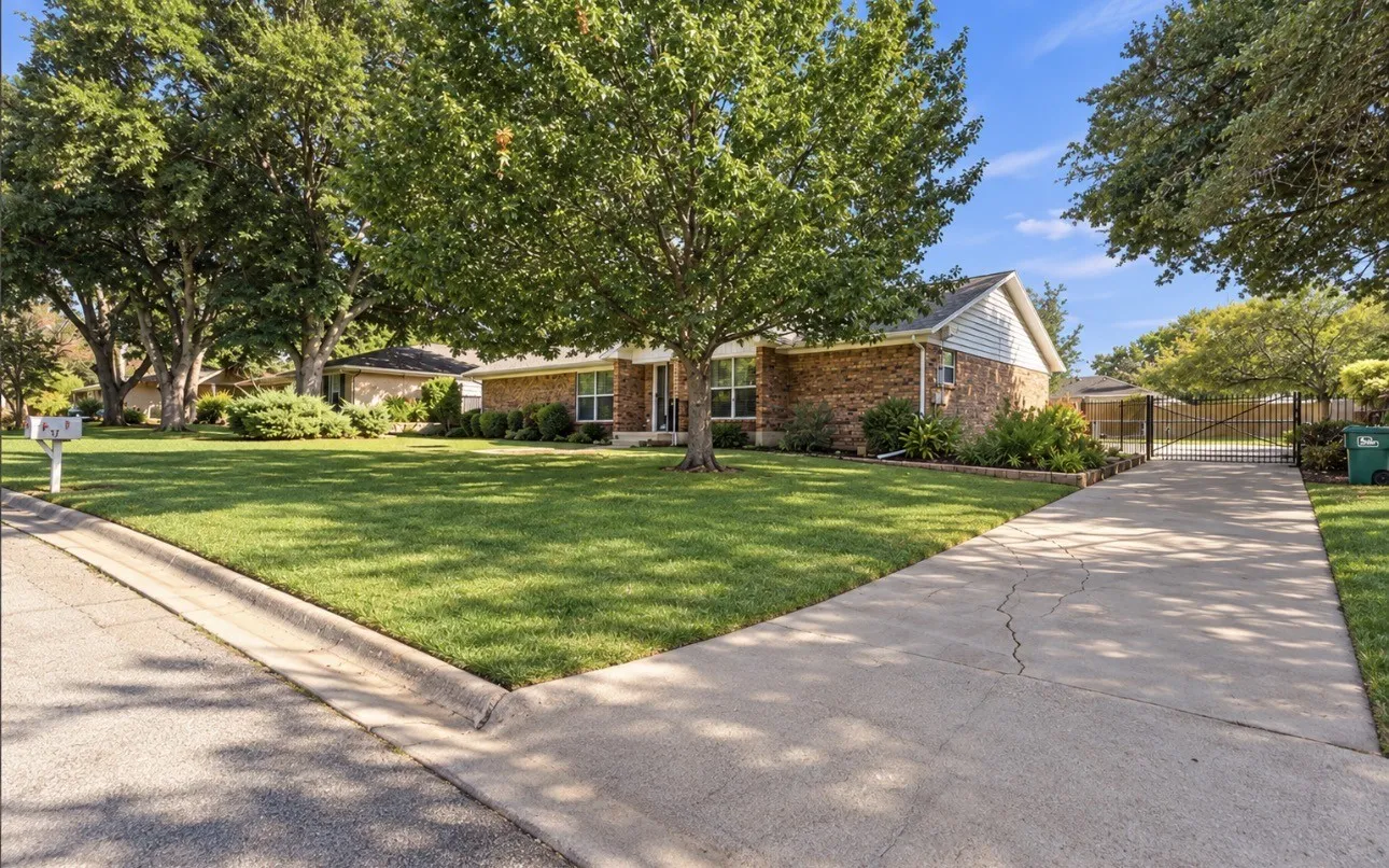 Brick and siding exterior with mature trees
