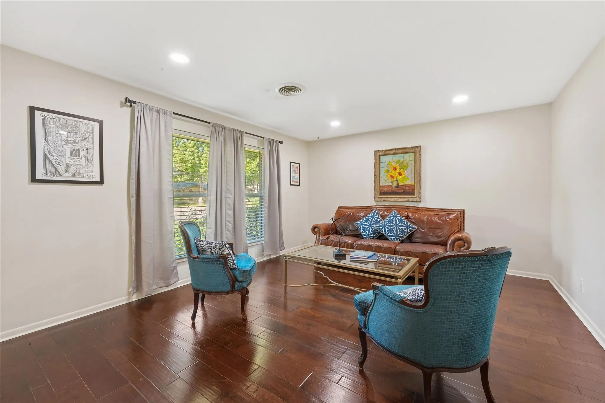 Hardwood flooring, recessed lighting, multiple windows, and a neutral color palette
