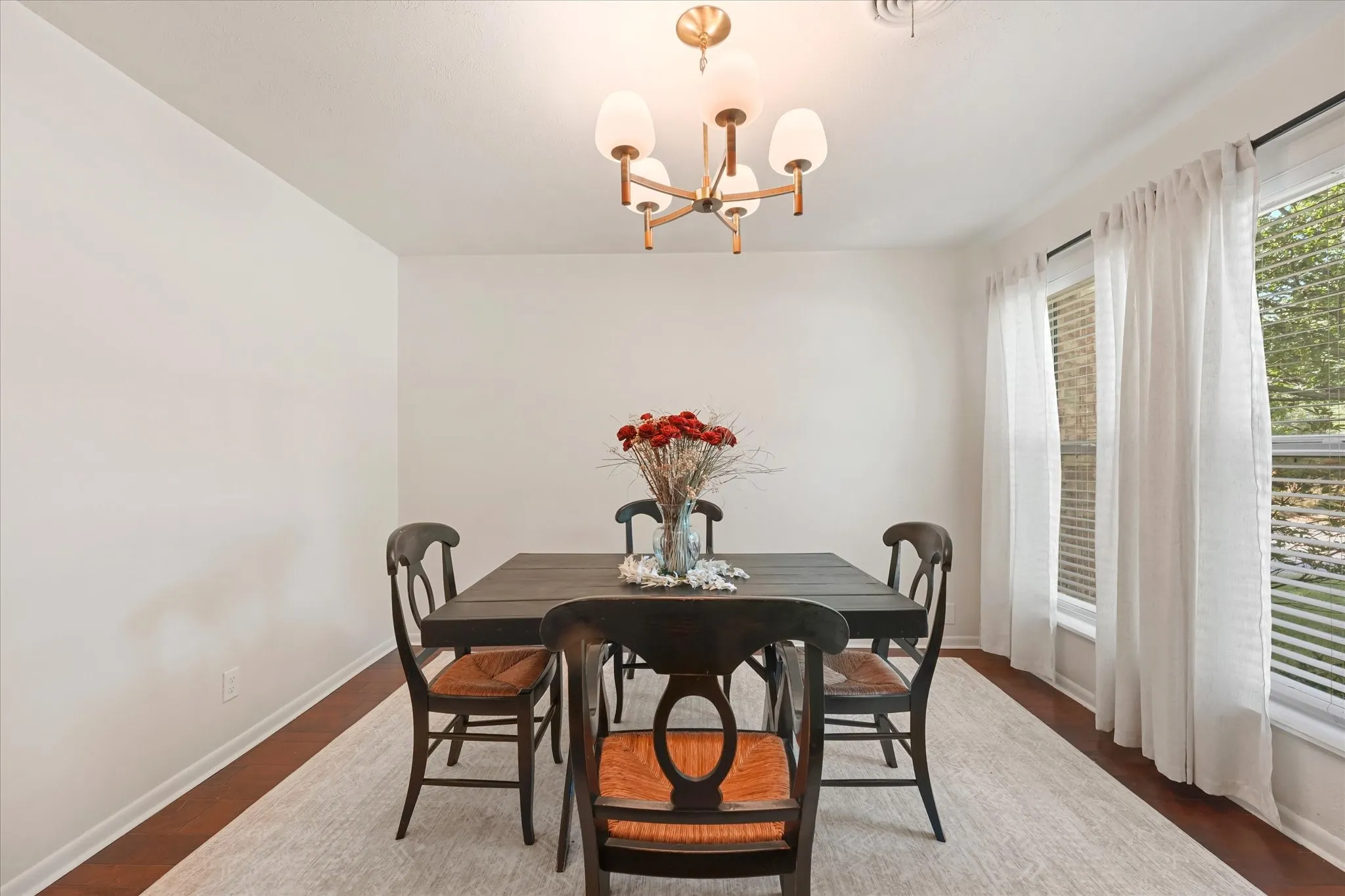 Recessed lighting, wood-finish flooring, and a contemporary chandelier