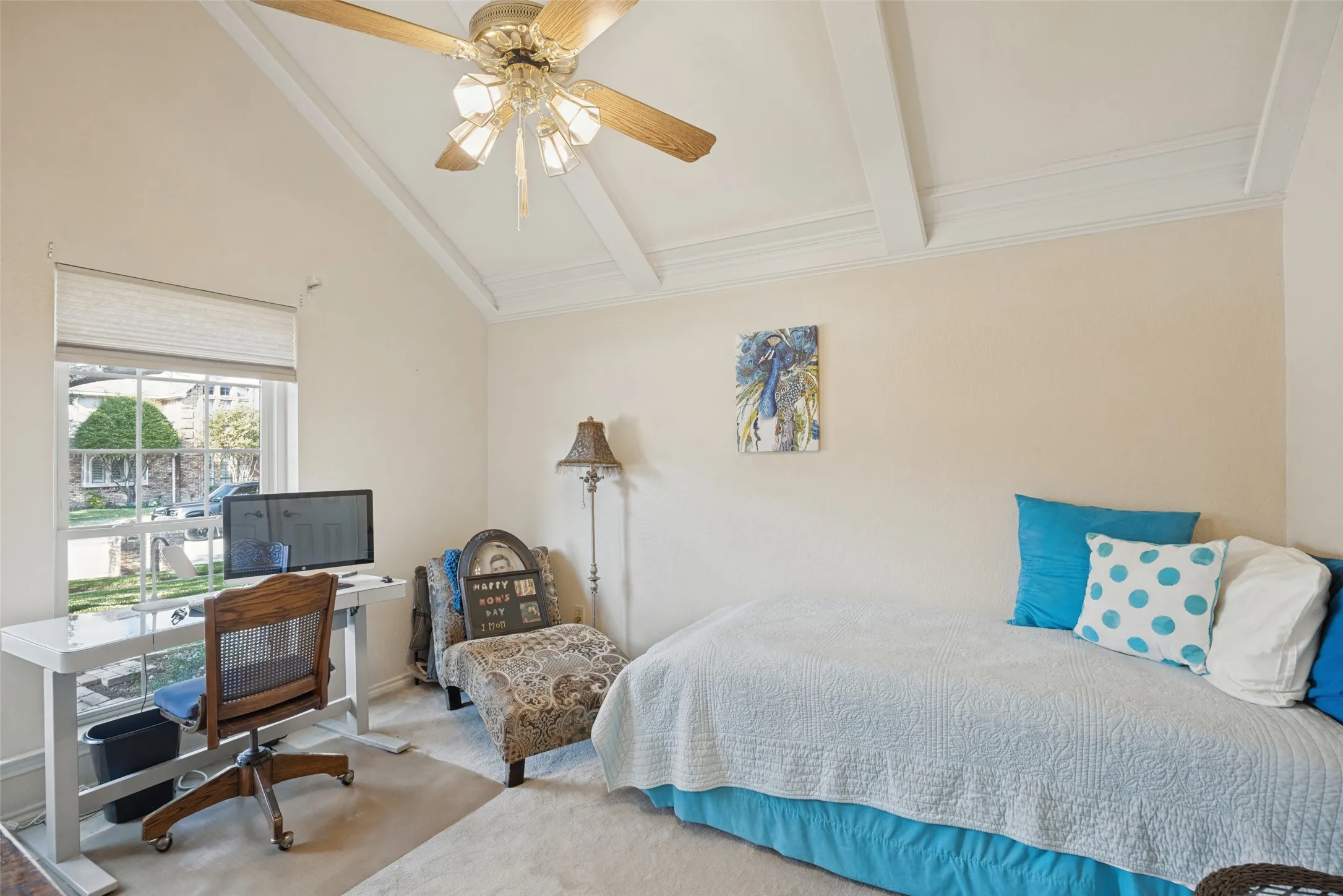 Vaulted ceiling with exposed beams, ceiling fan, and window with privacy blinds