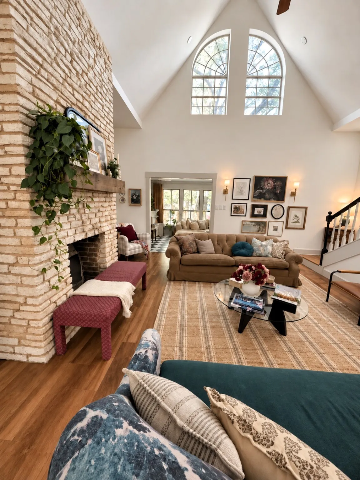 Living room with cathedral ceiling and floor to ceiling fireplace.