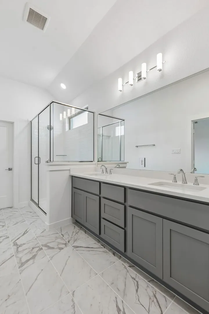 Primary Bathroom in the Claret home plan by Trophy Signature Homes – REPRESENTATIVE PHOTO